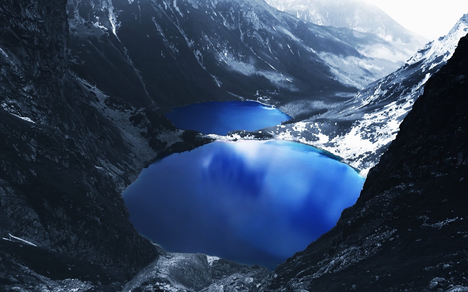 Two blue lakes nestled between snow-capped mountains HD Wallpaper
