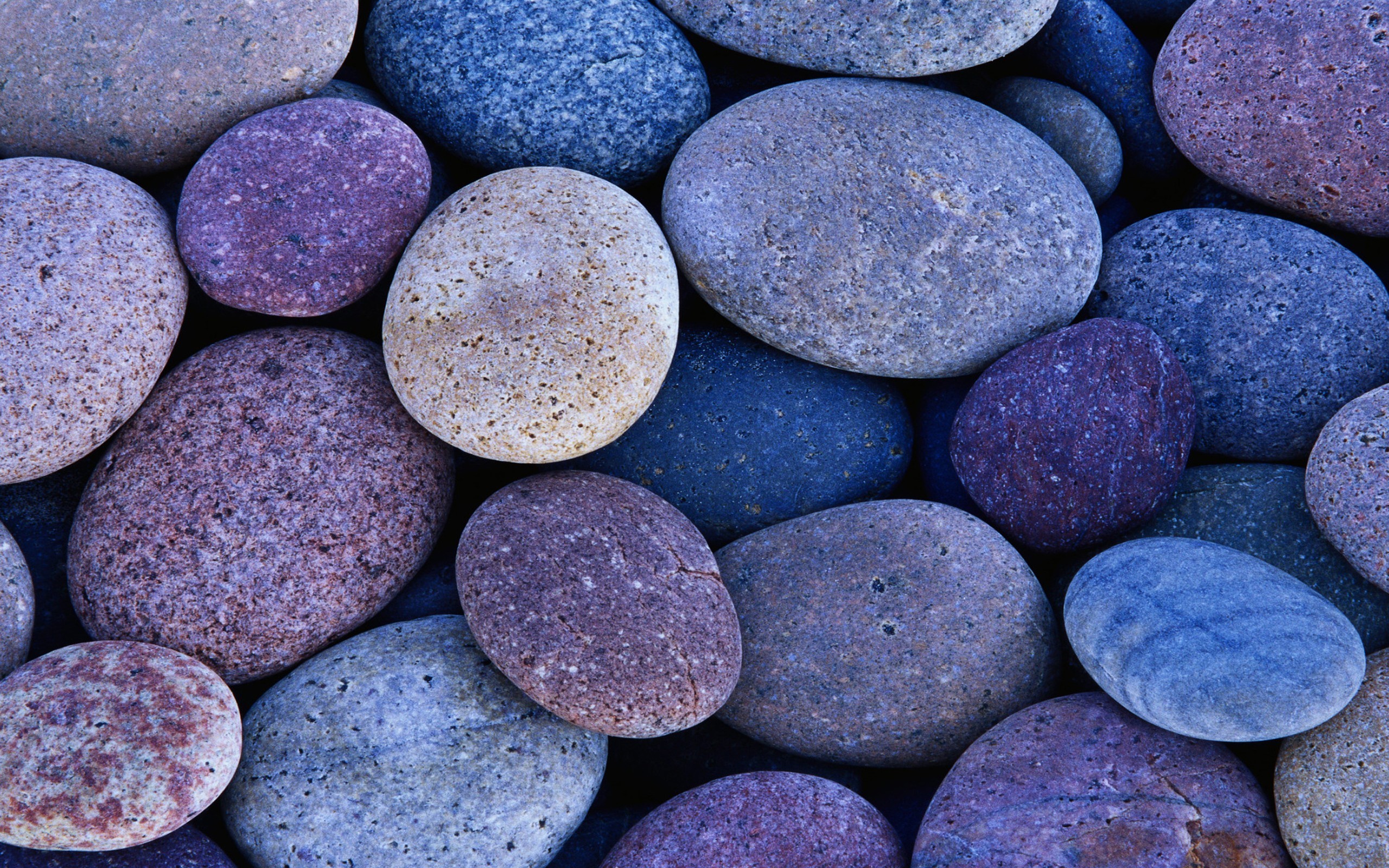 A close-up view of colorful, smooth stones. HD Wallpaper