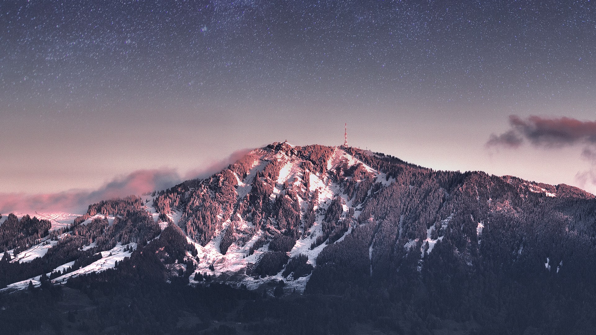 Snow-covered mountain peak under a starry sky HD Wallpaper