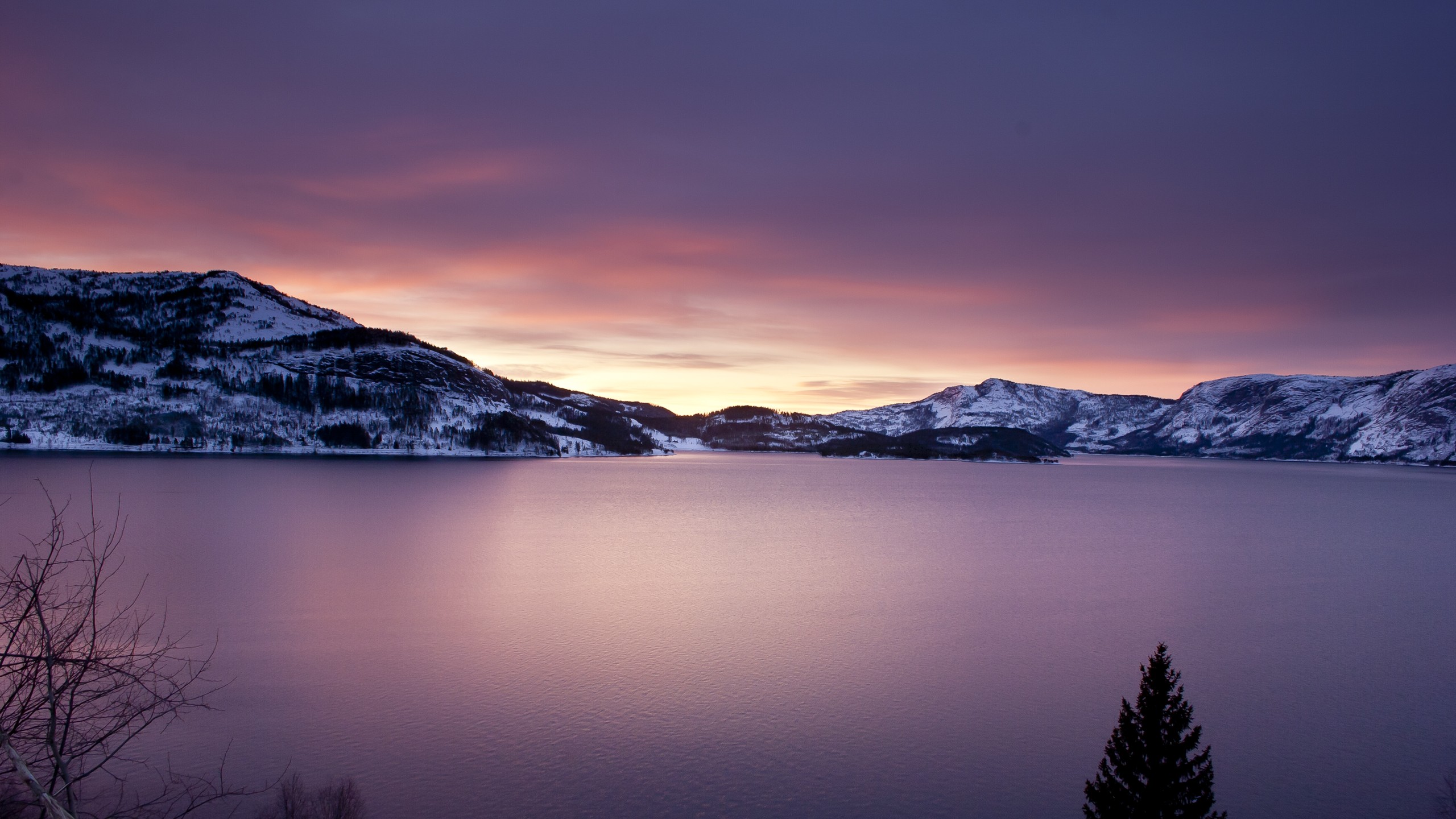 Winter landscape with snow-covered mountains and a lake at sunset HD Wallpaper