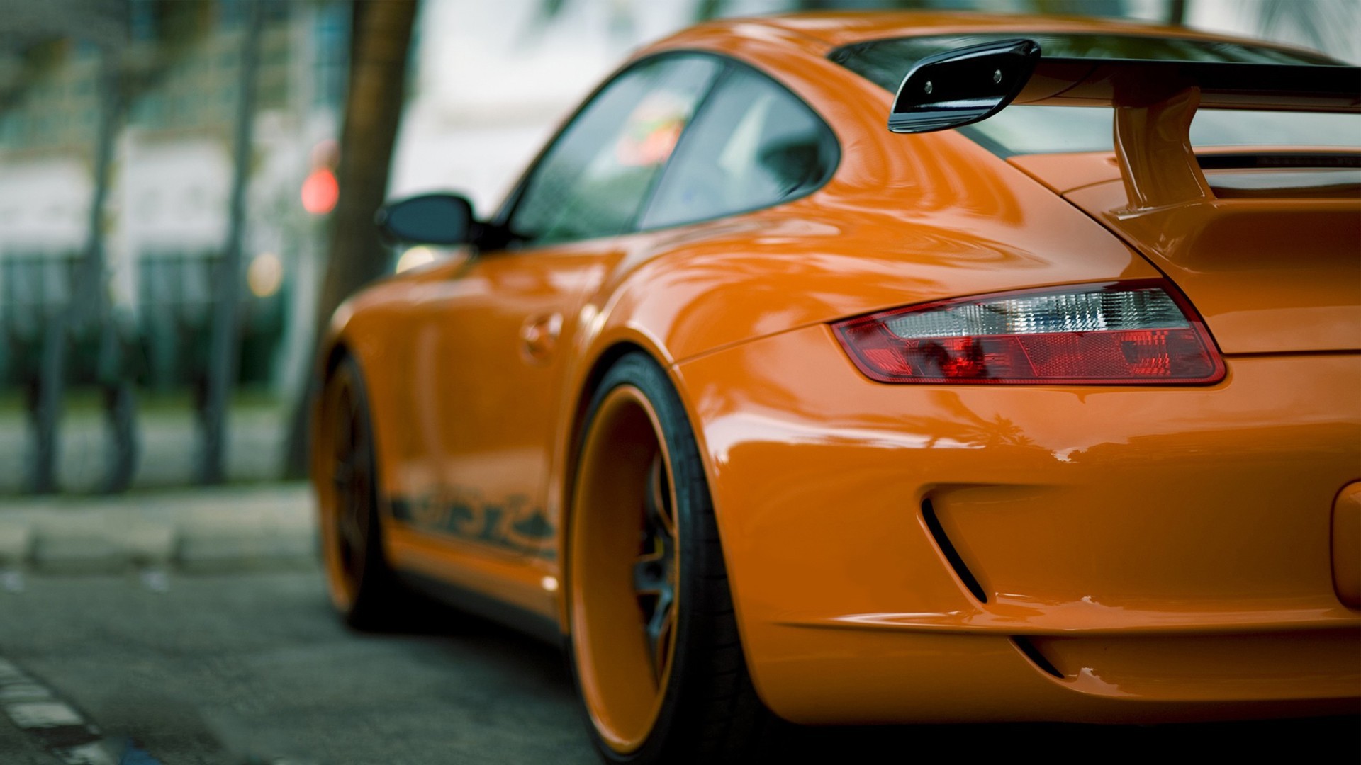 Orange Porsche 911 GT3 parked on a street HD Wallpaper