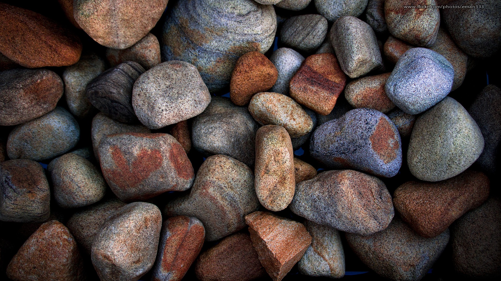 Close-up of colorful, textured river stones HD Wallpaper