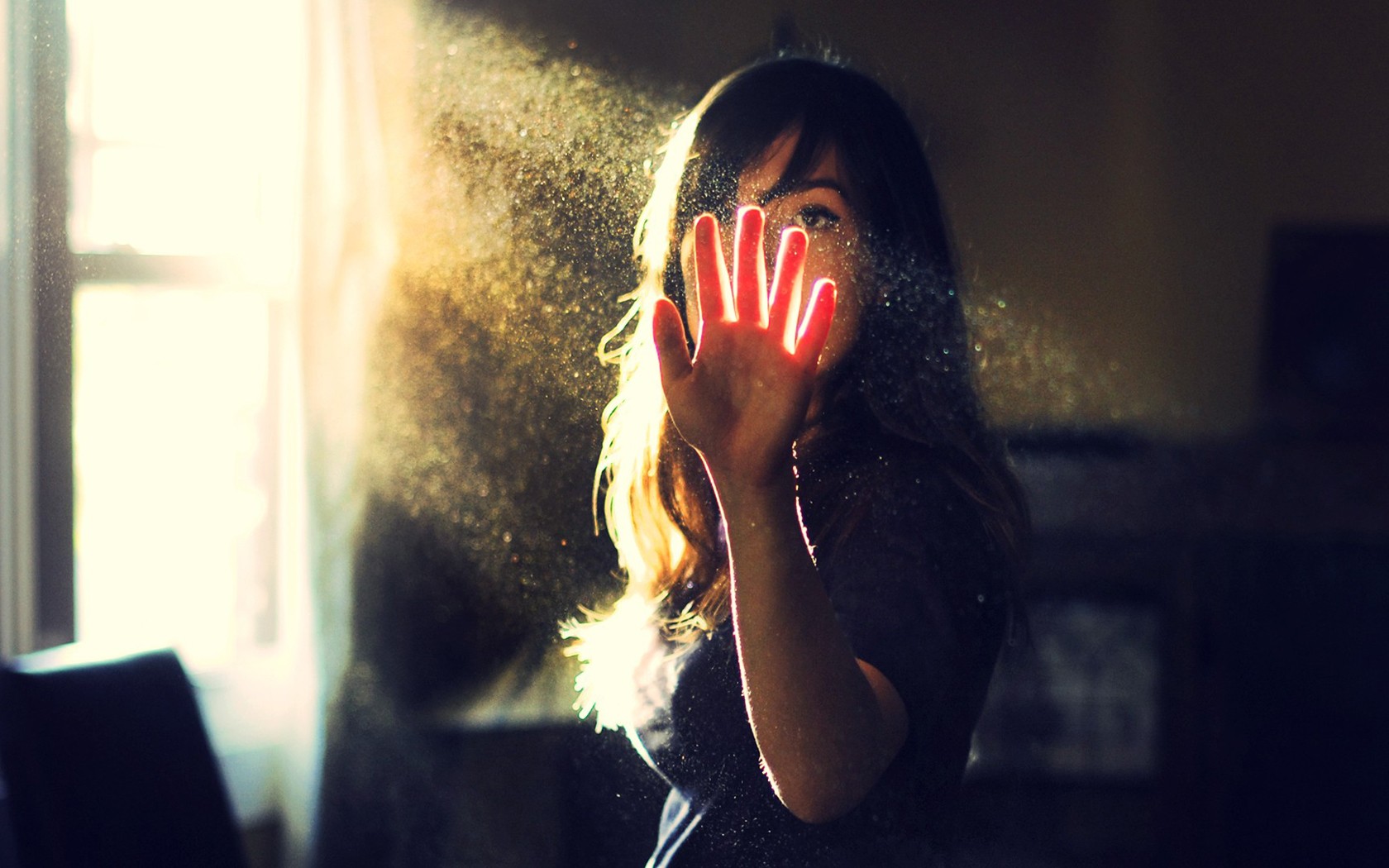 Woman holding hand up in dusty sunlight HD Wallpaper