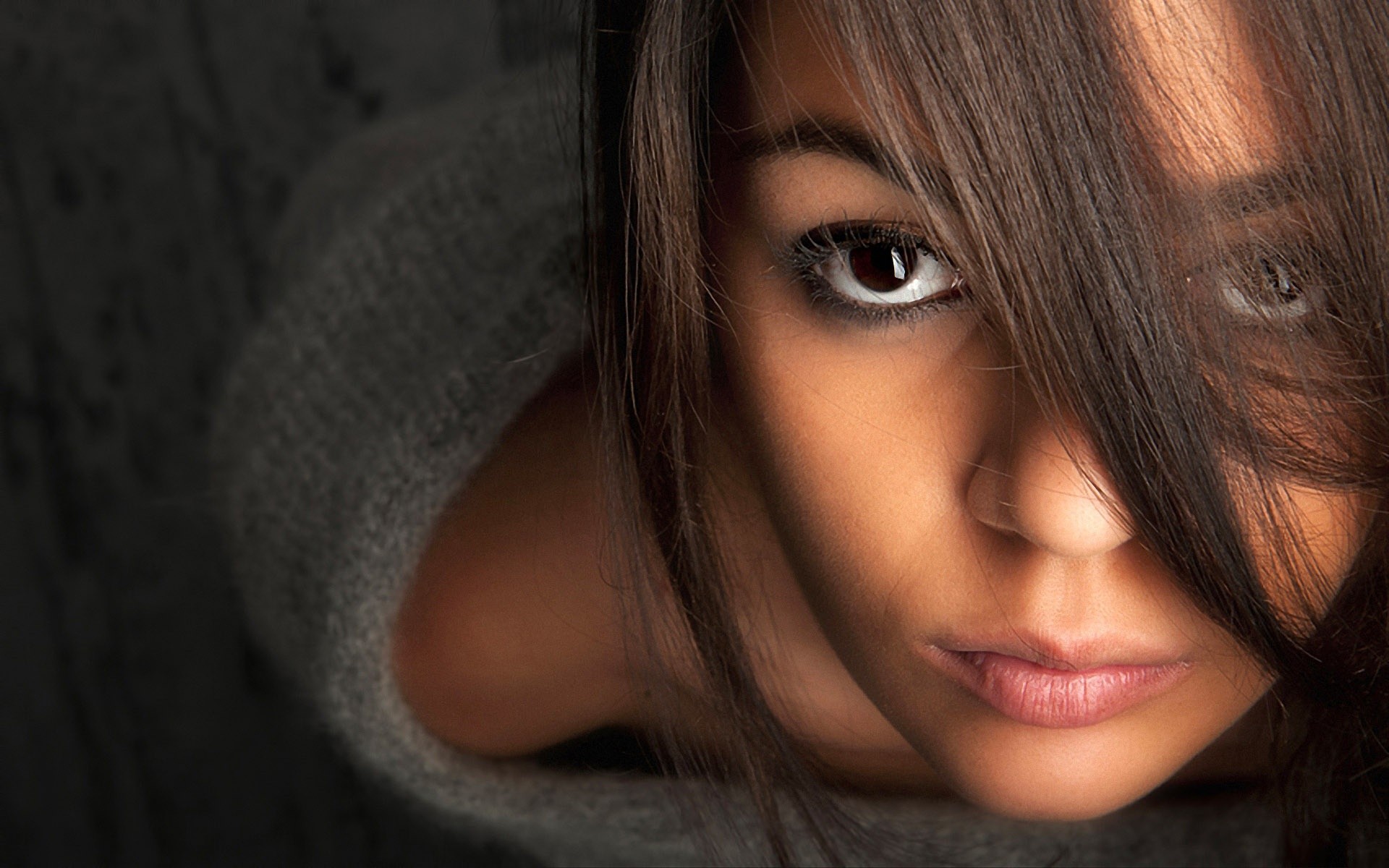 Close-up portrait of a woman with dark hair HD Wallpaper