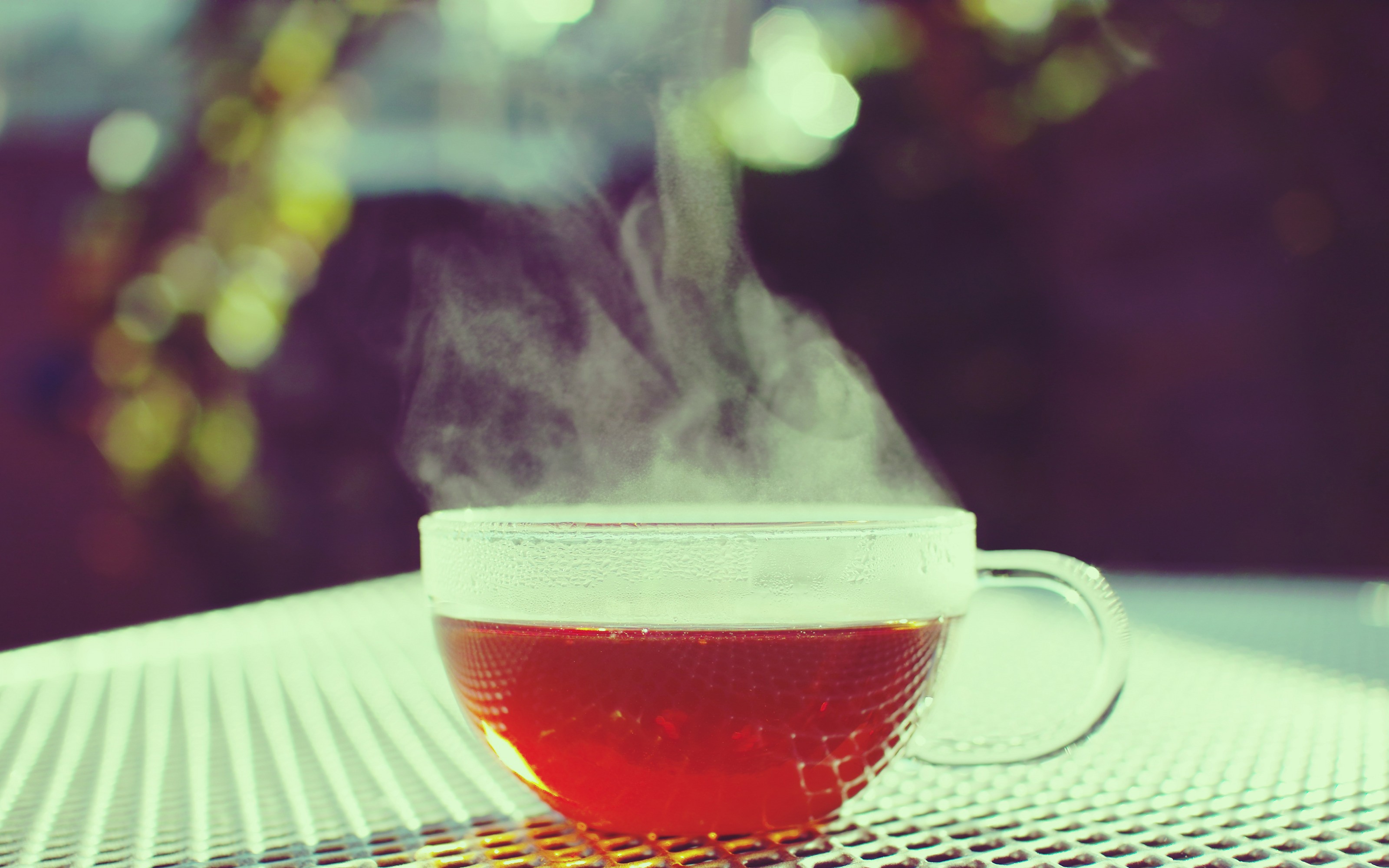 Steaming cup of tea on a table HD Wallpaper