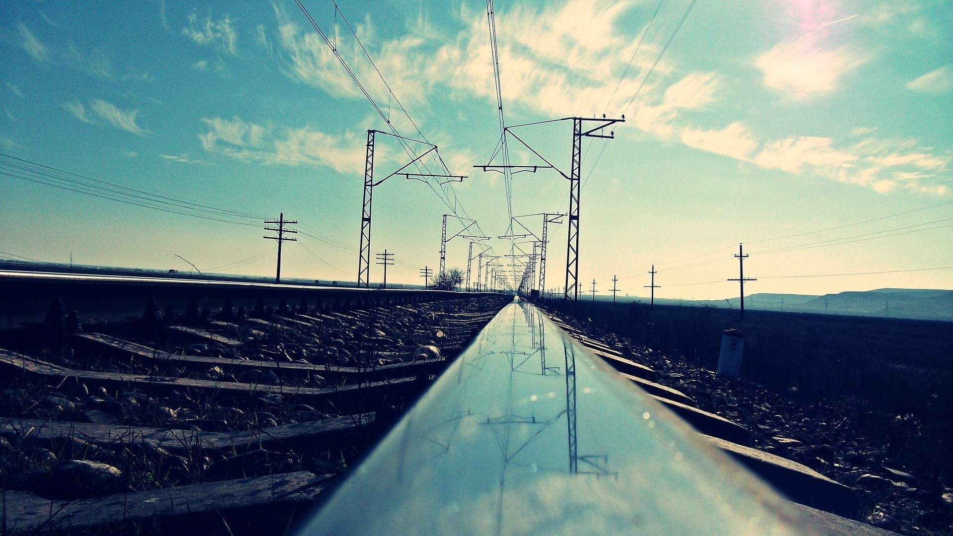Railway tracks with power lines and clouds HD Wallpaper