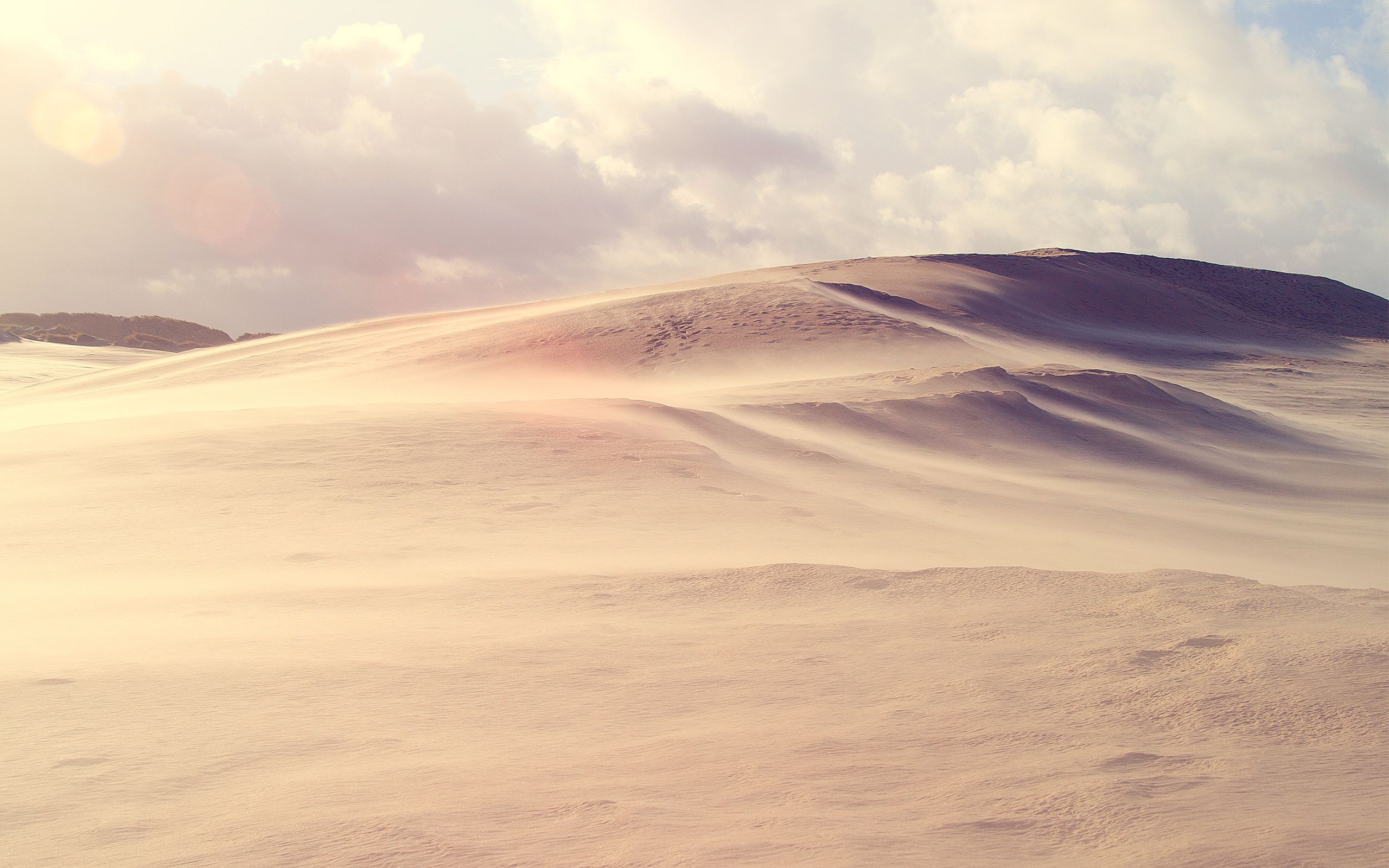 Sand dunes under a cloudy sky HD Wallpaper