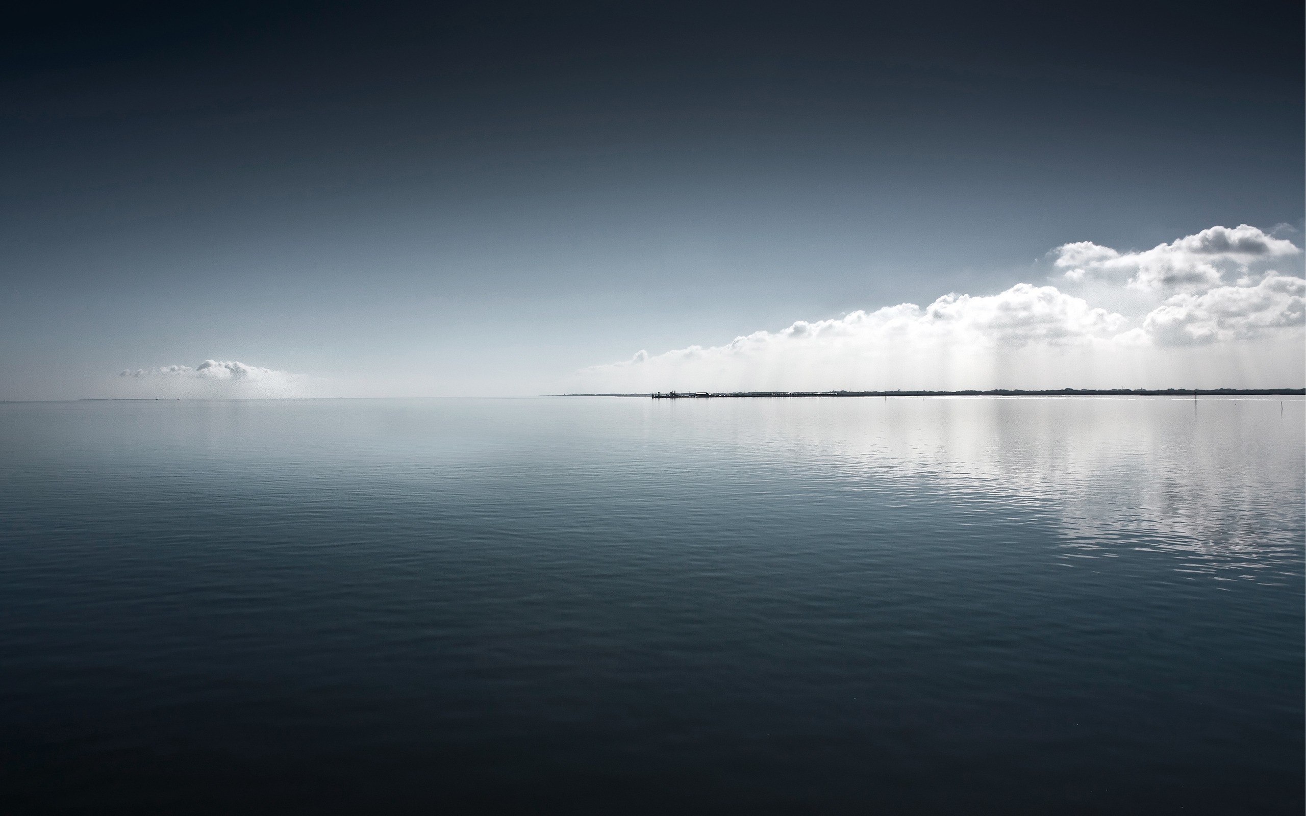 Vast calm sea under a cloudy sky HD Wallpaper