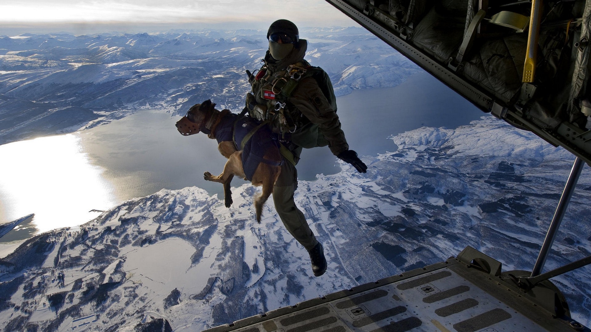 Soldier and dog parachute over snowy mountains and lake HD Wallpaper