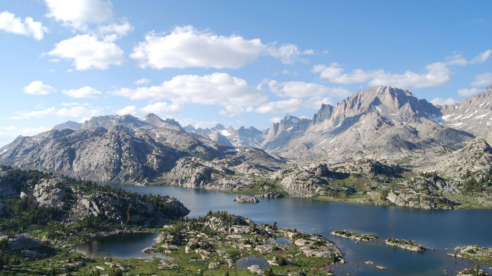 Mountains and lake under a cloudy sky HD Wallpaper