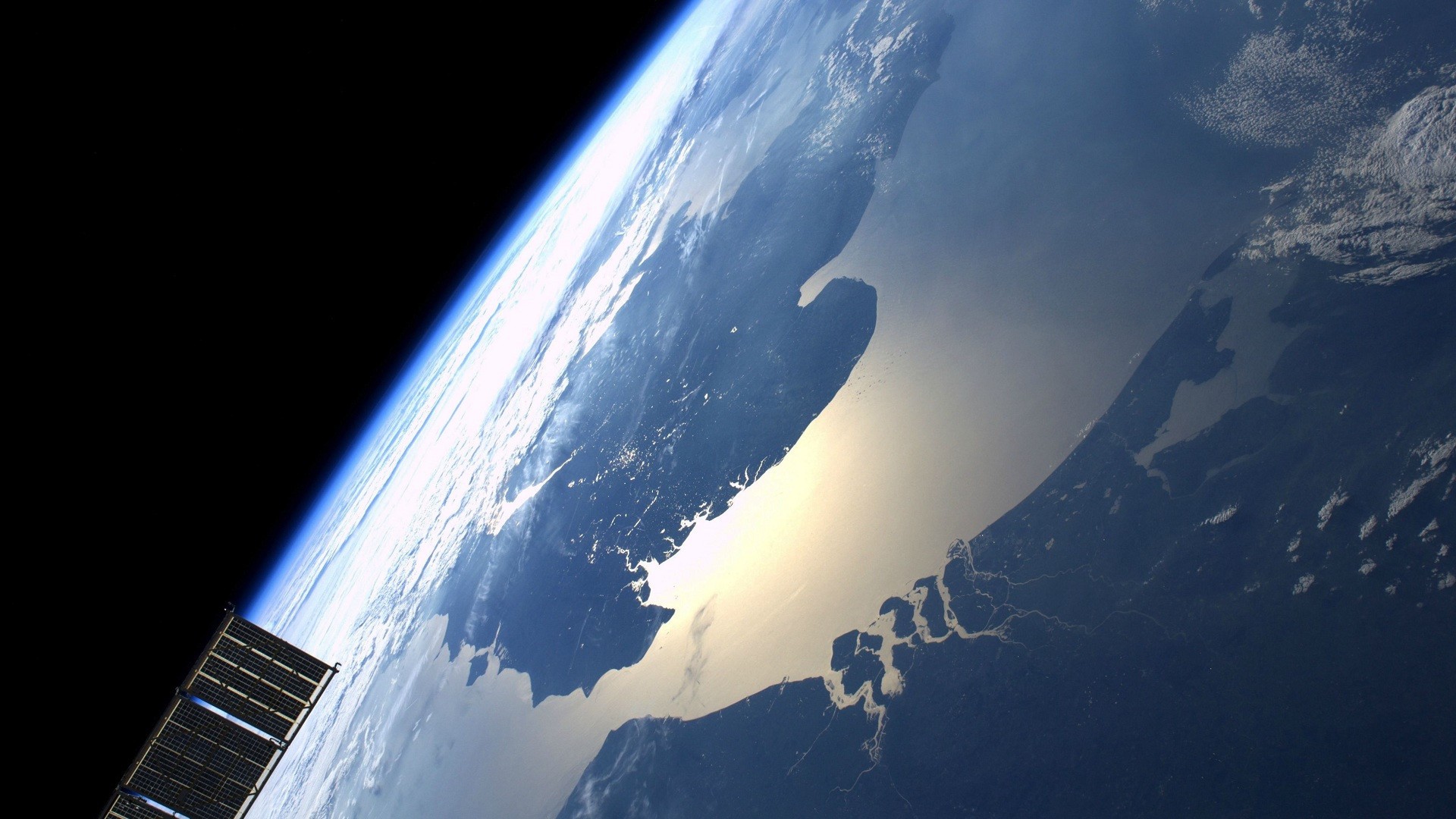 Earth from space with a satellite panel HD Wallpaper