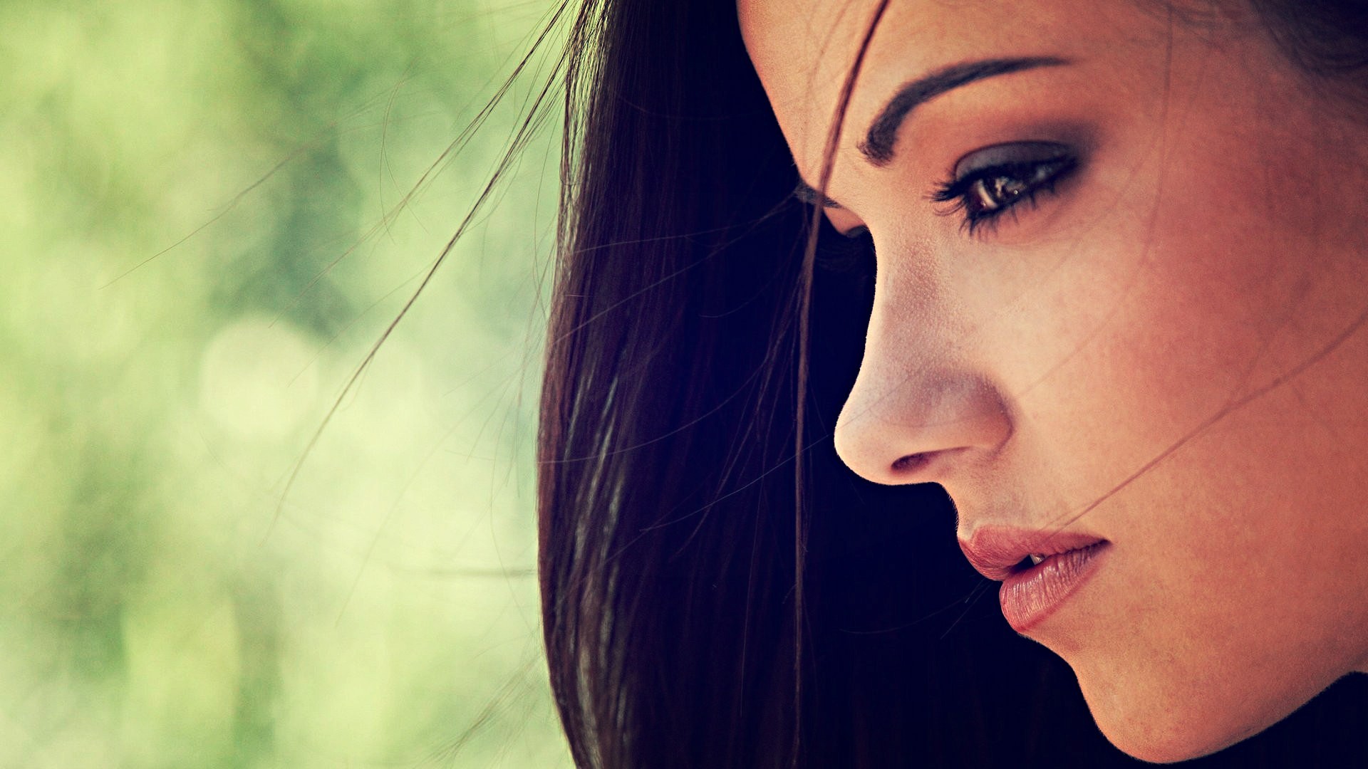 Profile of a brunette woman with dark eyes HD Wallpaper