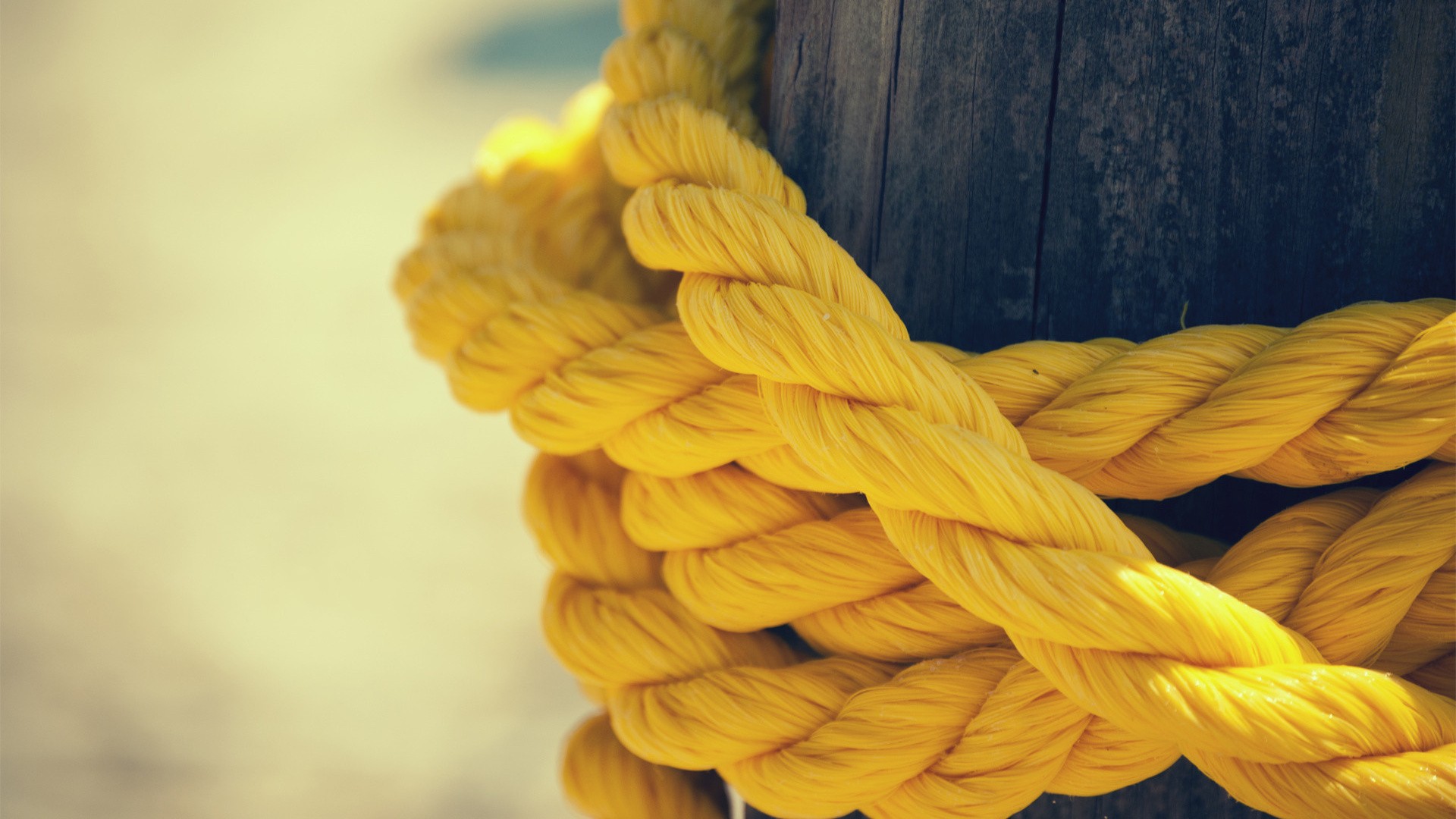 Yellow rope tied around a wooden post HD Wallpaper
