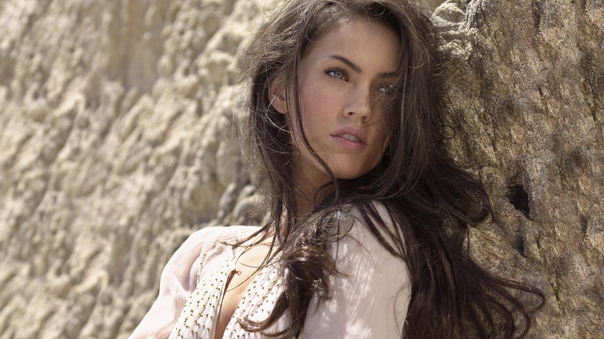 Megan Fox leaning against a rock face HD Wallpaper
