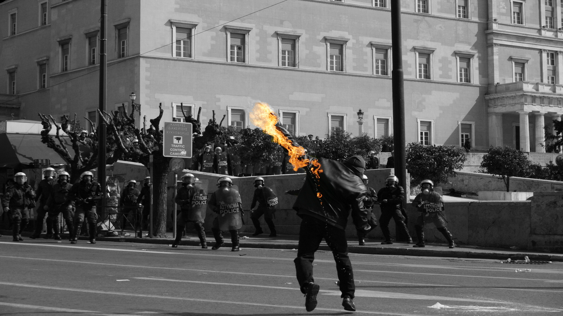 Man throws Molotov cocktail at police during riots HD Wallpaper