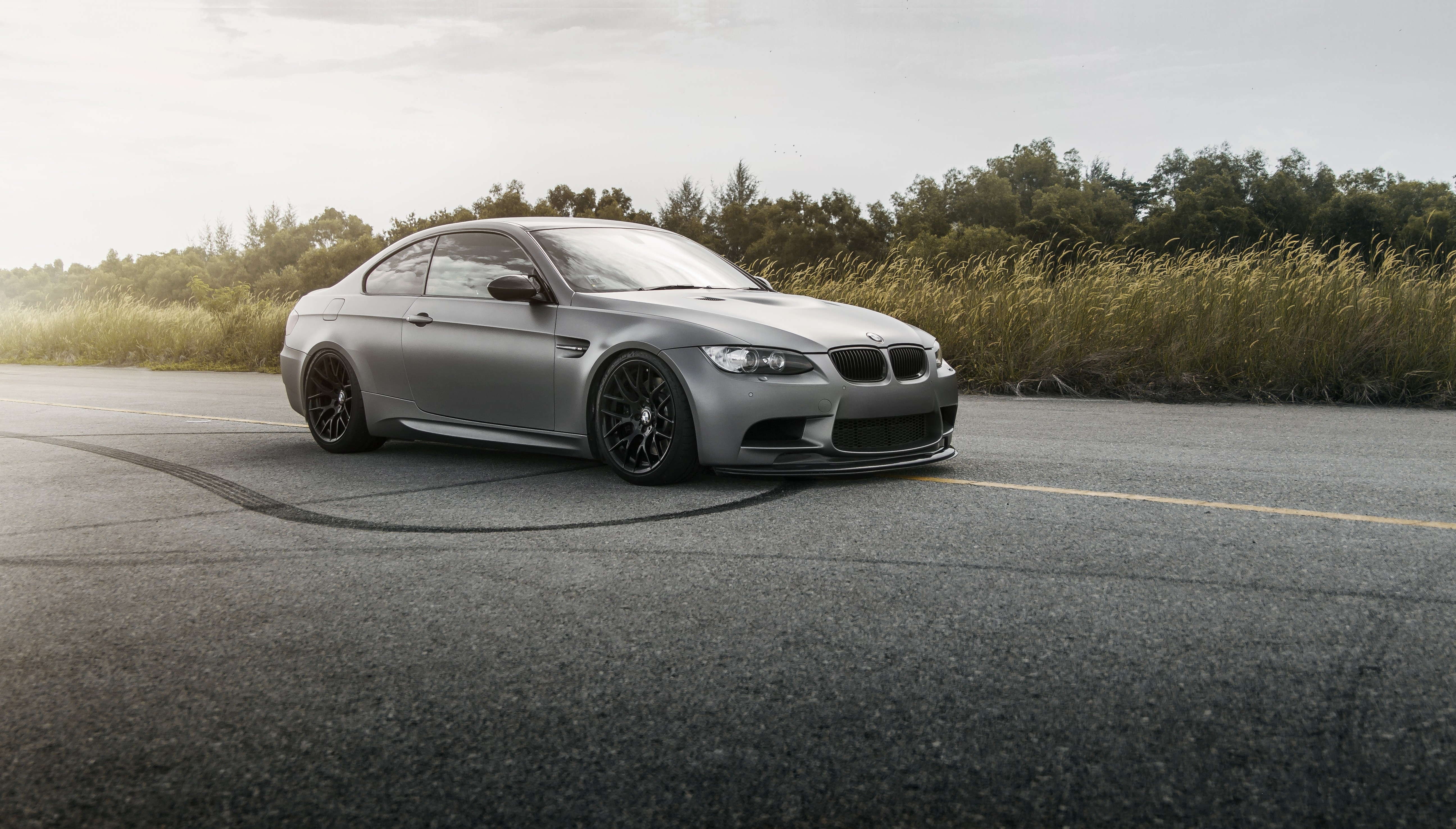 Gray BMW E92 M3 on asphalt with tire marks HD Wallpaper