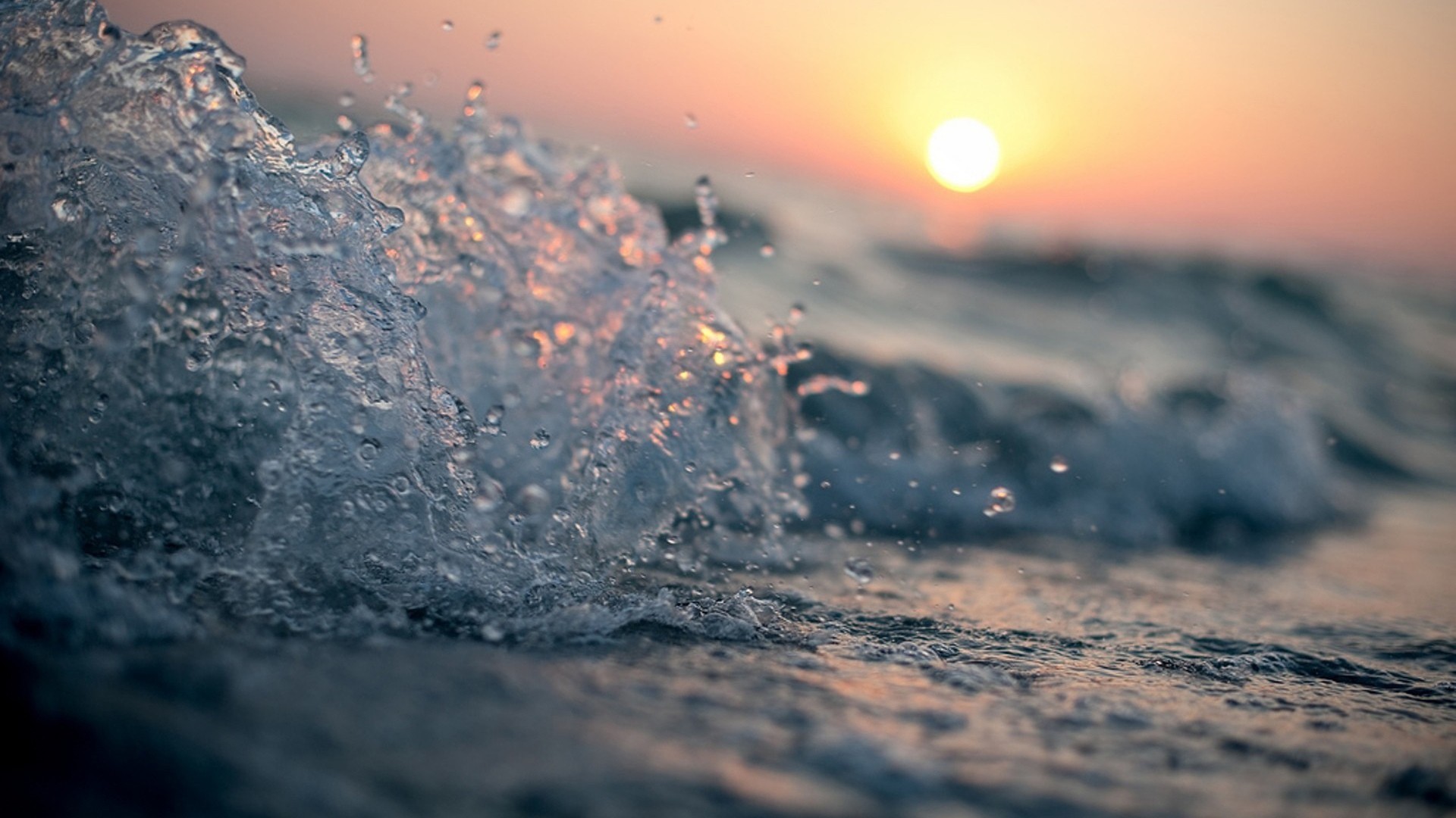Close-up of ocean waves at sunset HD Wallpaper