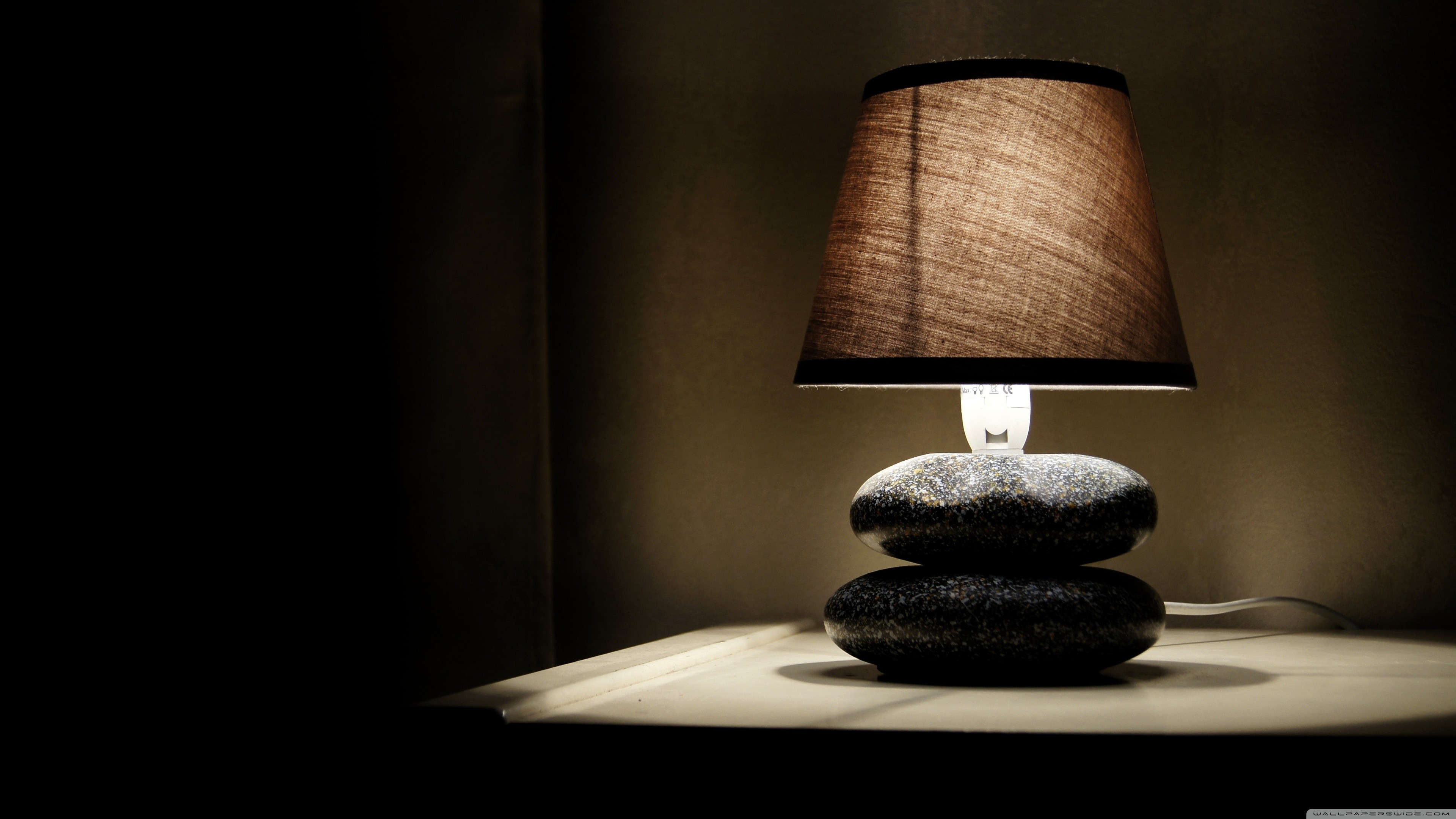 Table lamp with stacked stone base HD Wallpaper