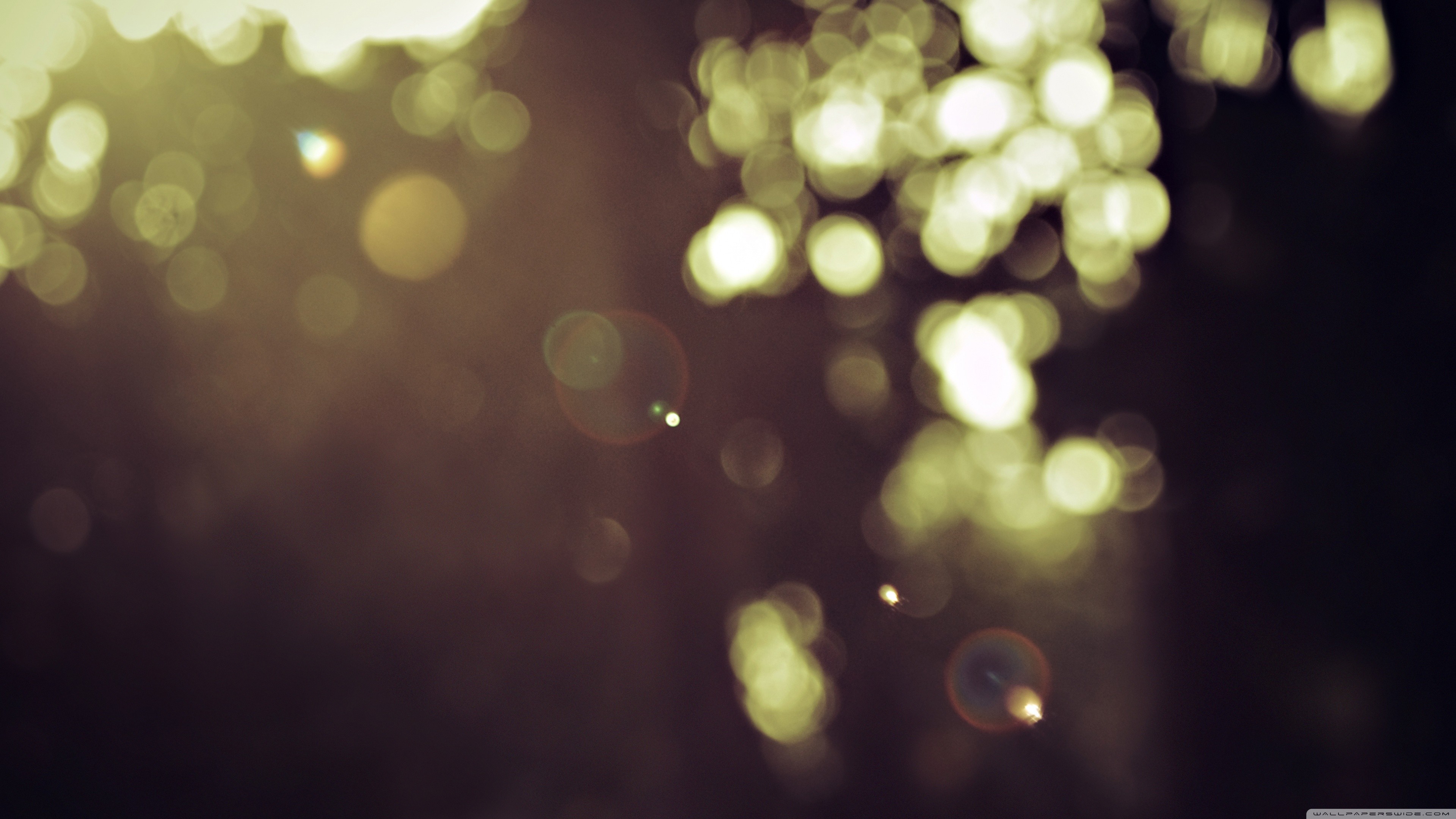 Bokeh lights in a dark, moody setting HD Wallpaper