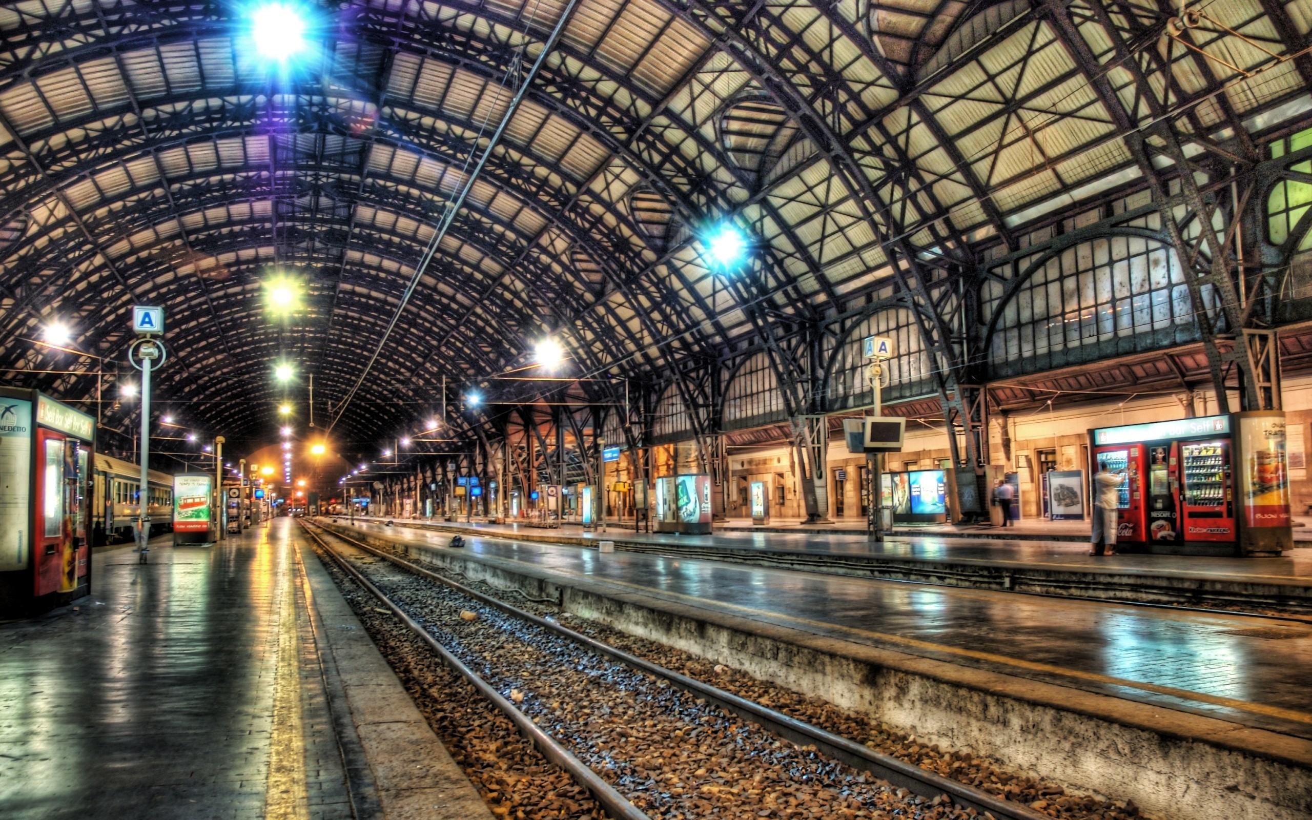 Train station interior with arched roof and tracks HD Wallpaper
