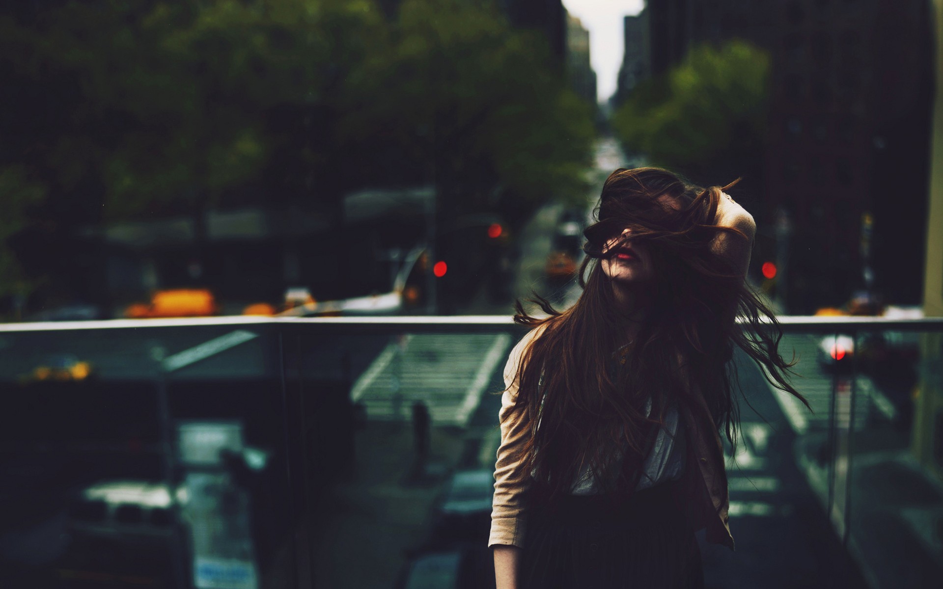 Woman with long hair on a balcony overlooking a city HD Wallpaper