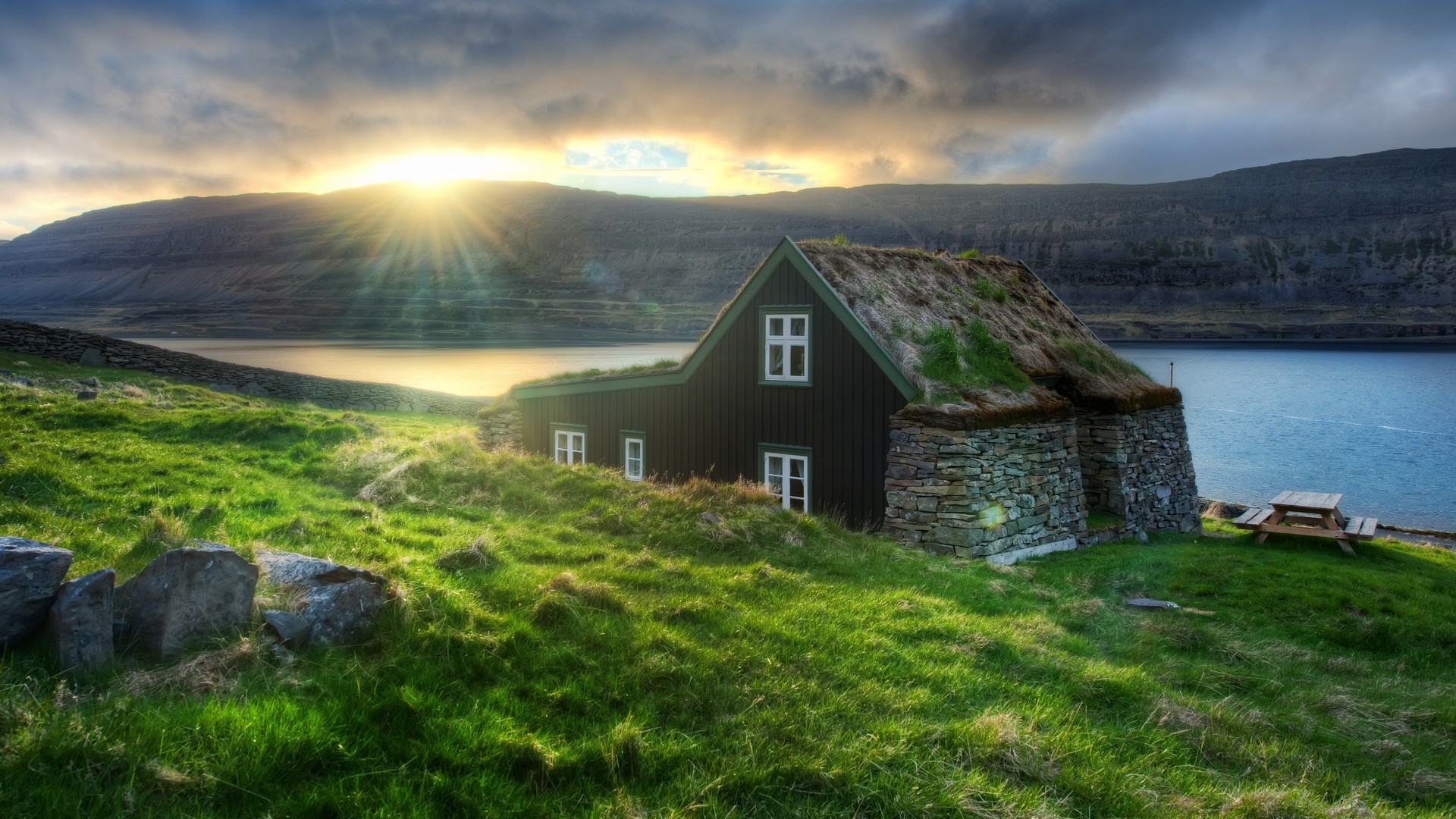 Traditional house with grass roof by a fjord in Iceland HD Wallpaper