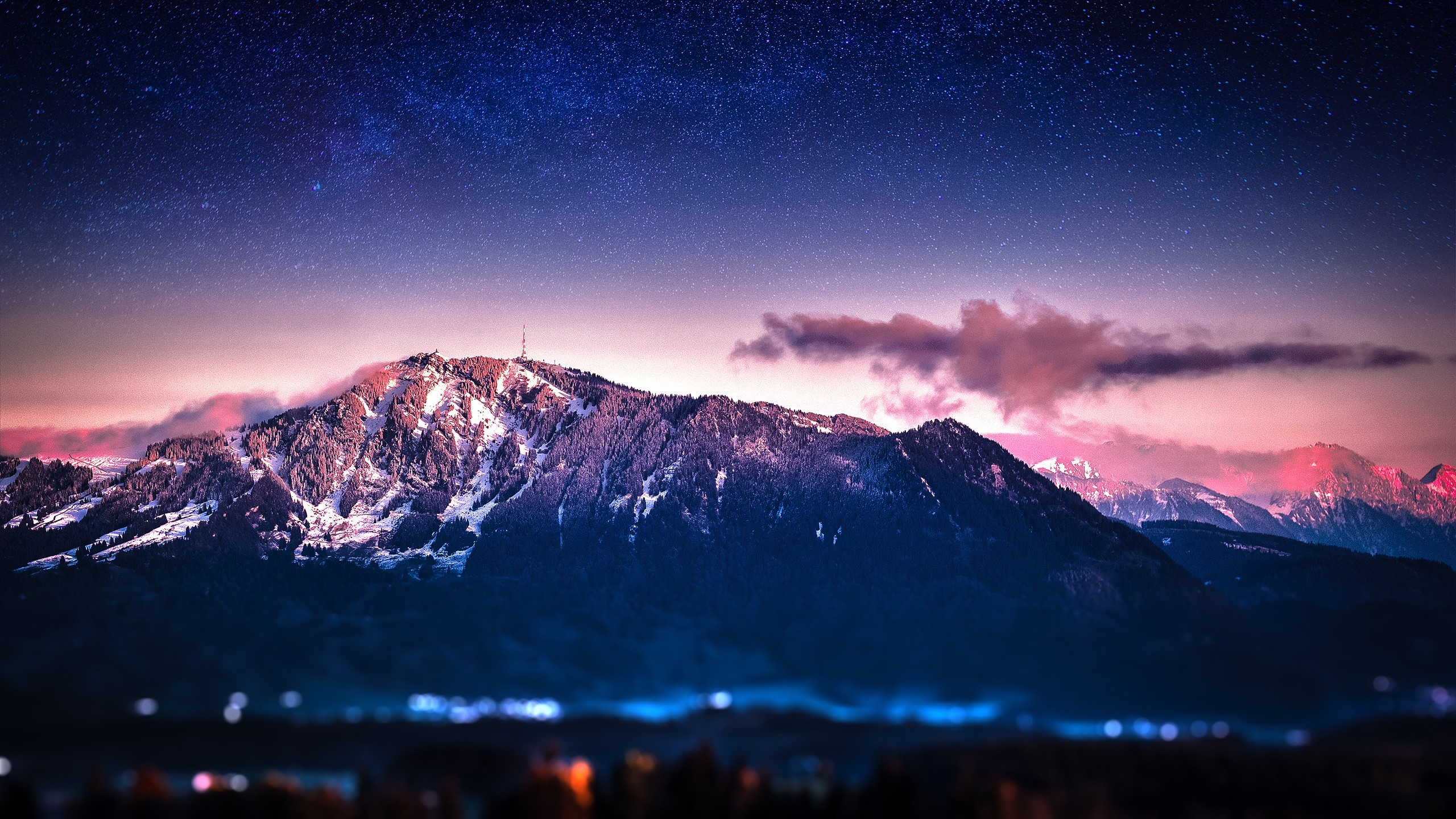 Mountains under a starry night sky with pink clouds HD Wallpaper