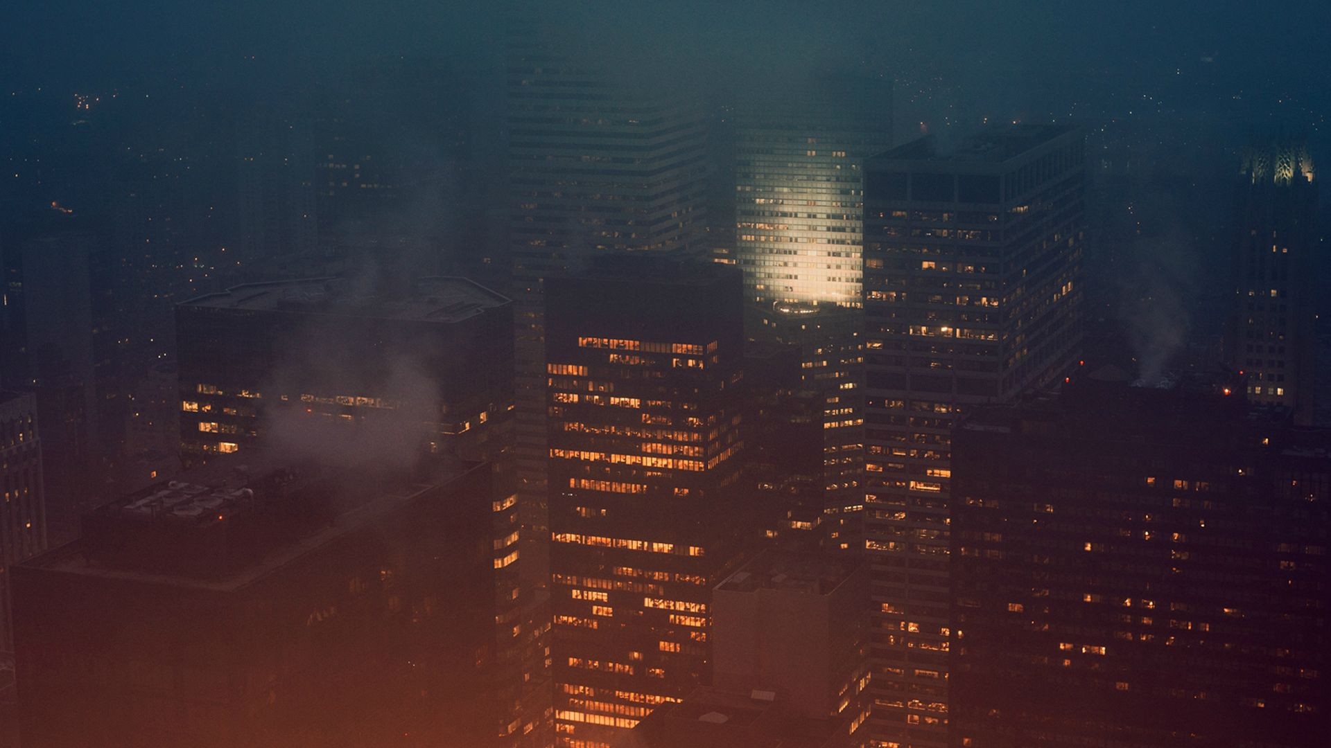 Cityscape at night with skyscrapers and clouds HD Wallpaper