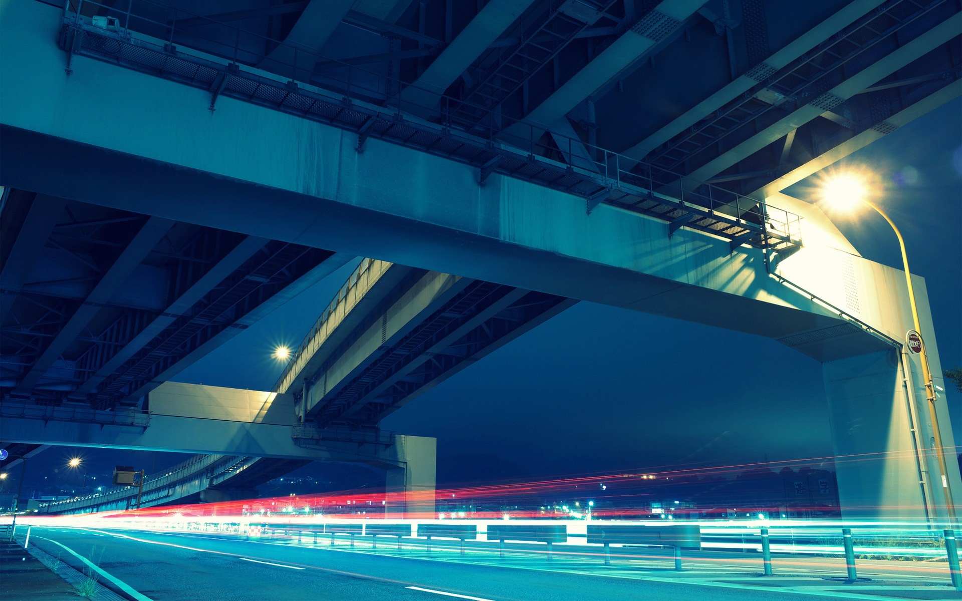 Long exposure of a highway under a bridge in Japan at night HD Wallpaper