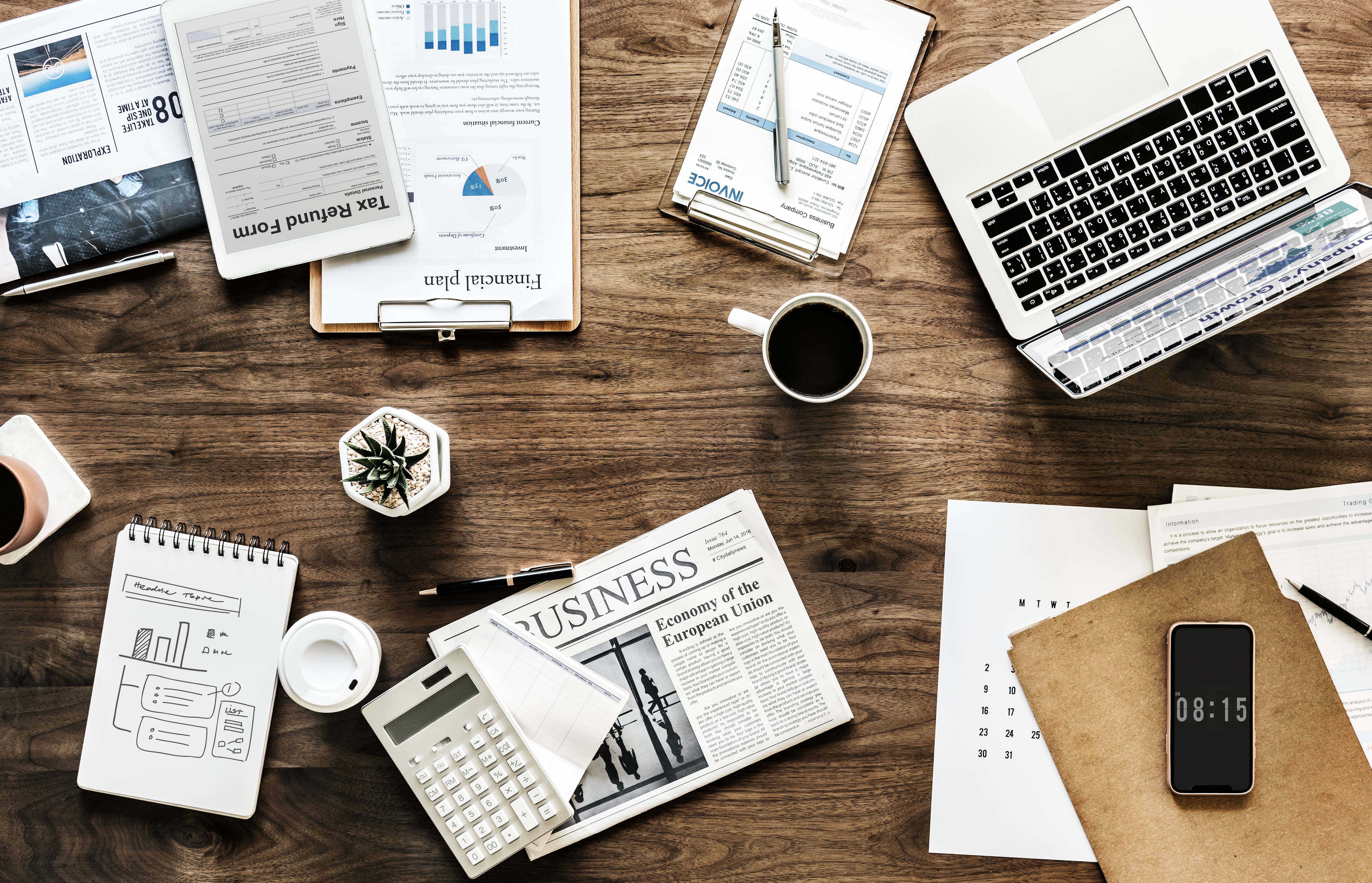 Business and finance documents on a wooden desk HD Wallpaper