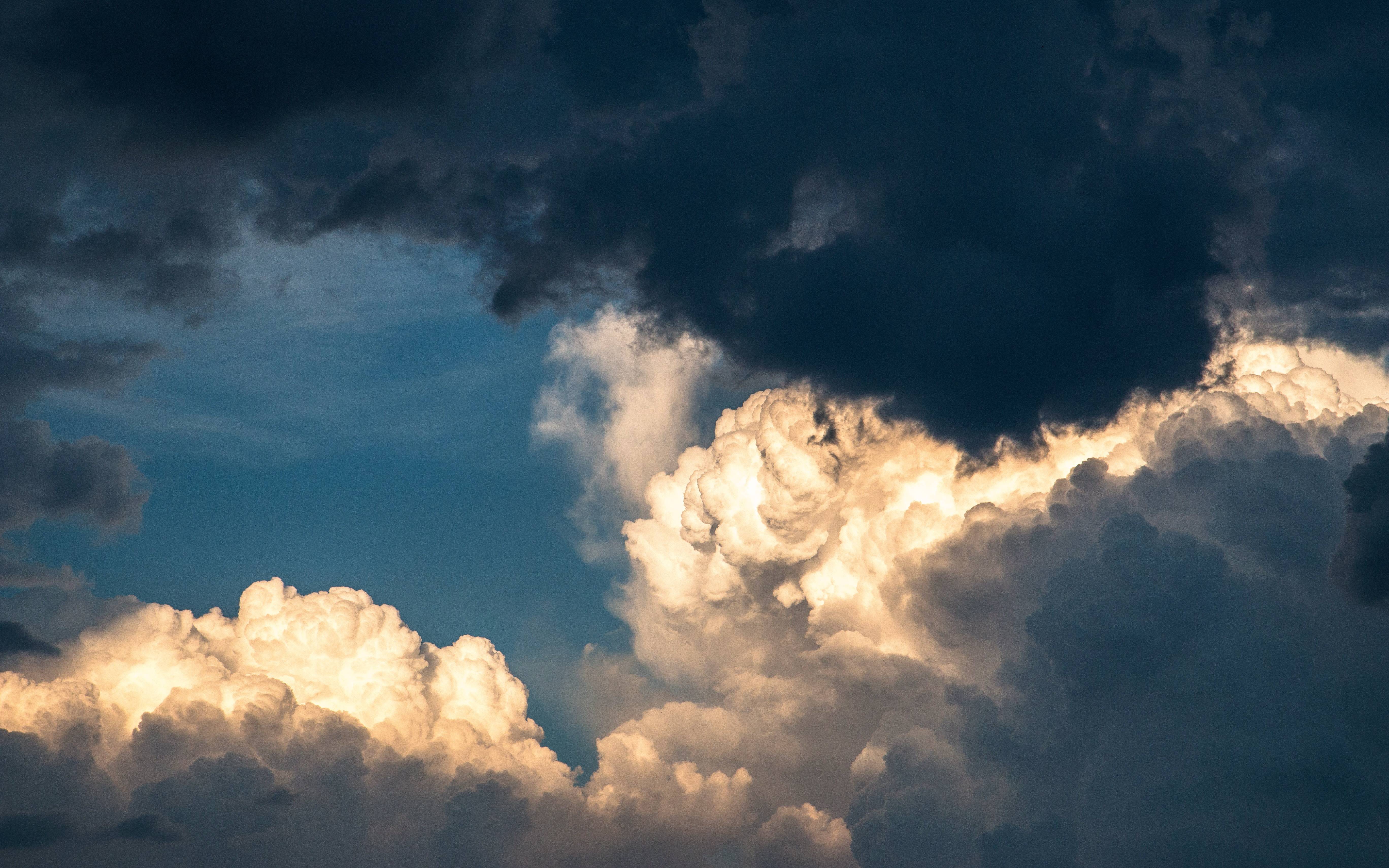Dramatic storm clouds illuminated by sunlight HD Wallpaper