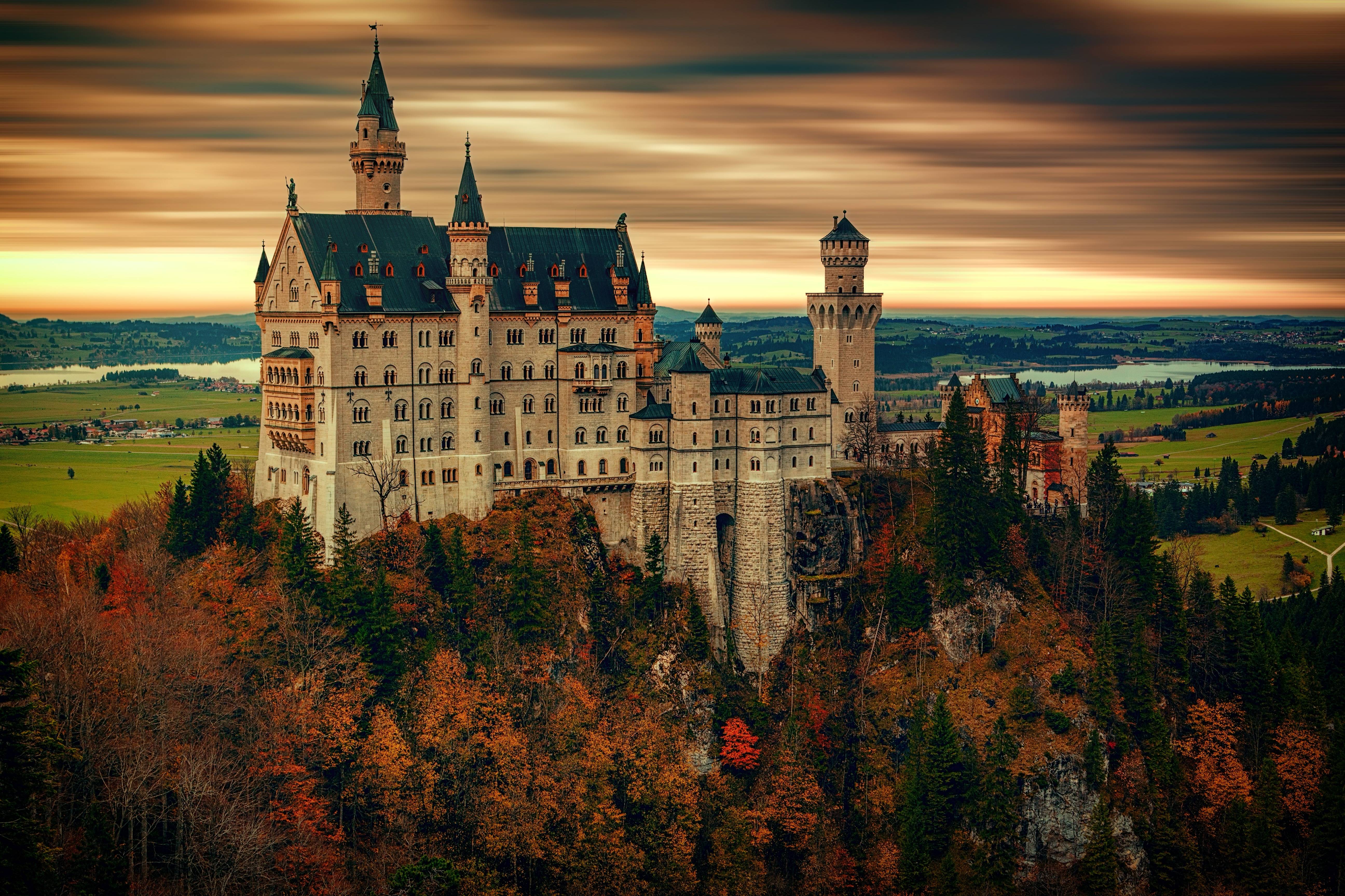 Neuschwanstein Castle in autumn at sunset HD Wallpaper