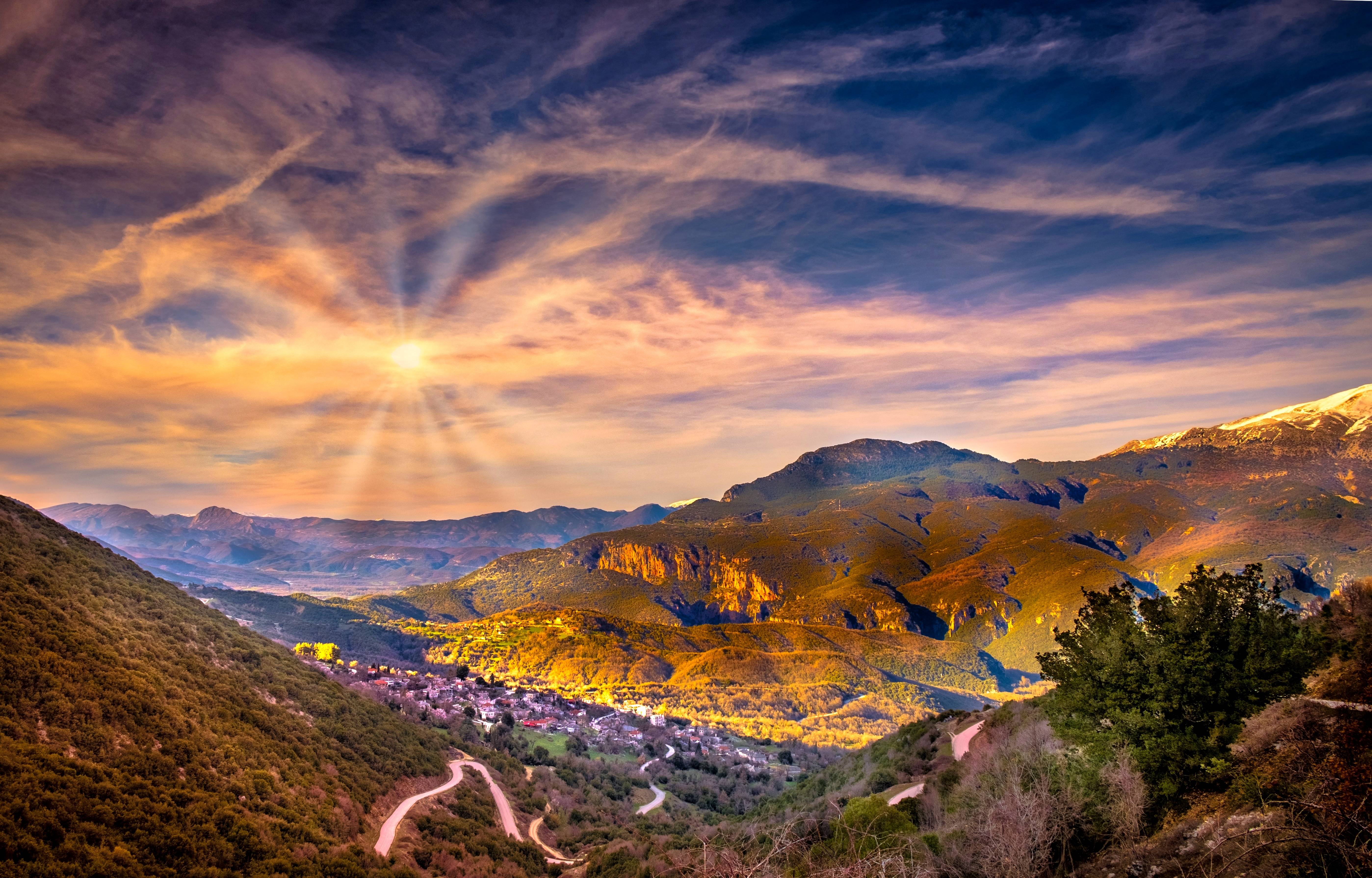 Village in Greece at sunset with sun rays HD Wallpaper