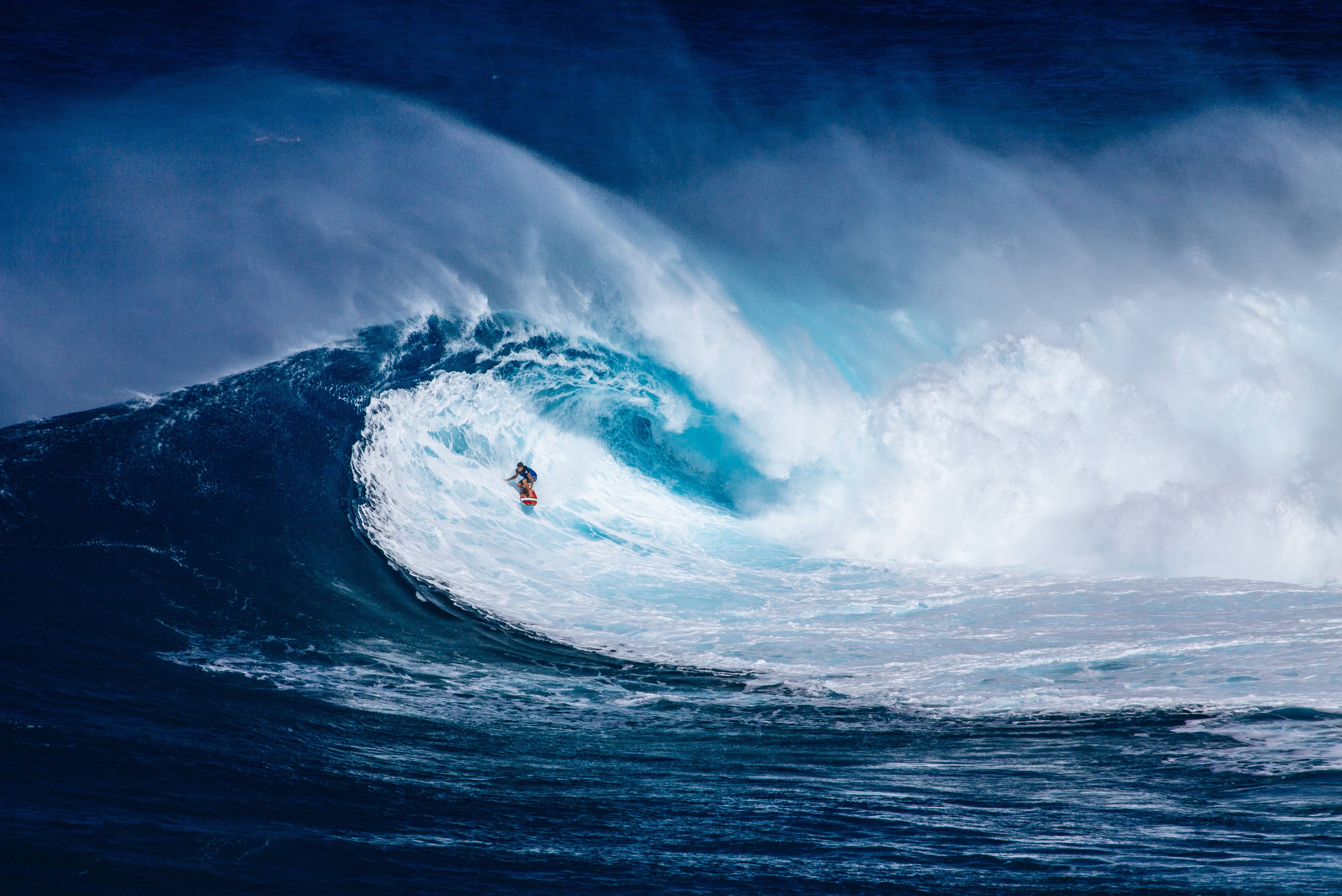 Surfer riding a massive ocean wave HD Wallpaper