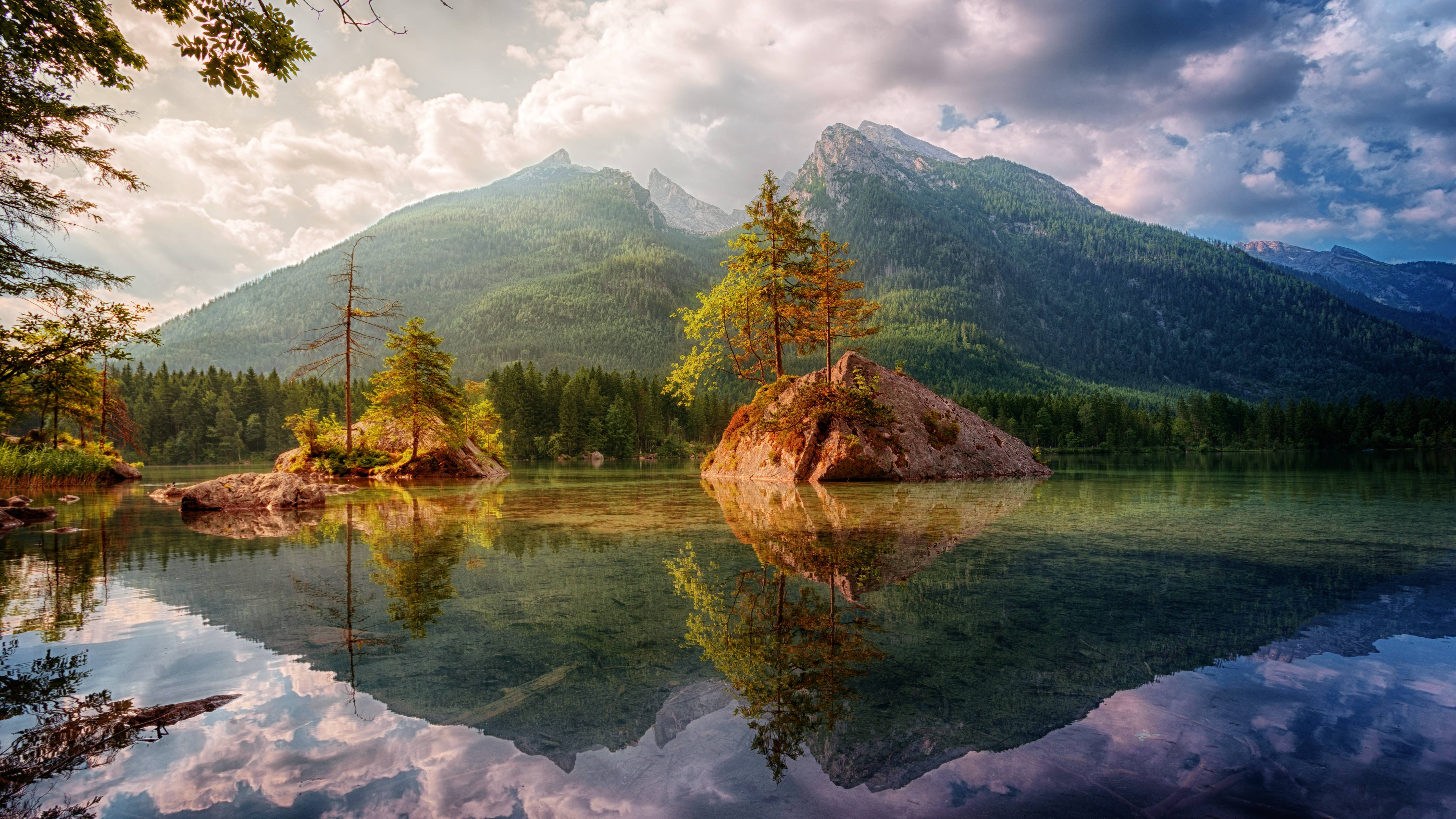Lake with islands and mountains reflected in water HD Wallpaper