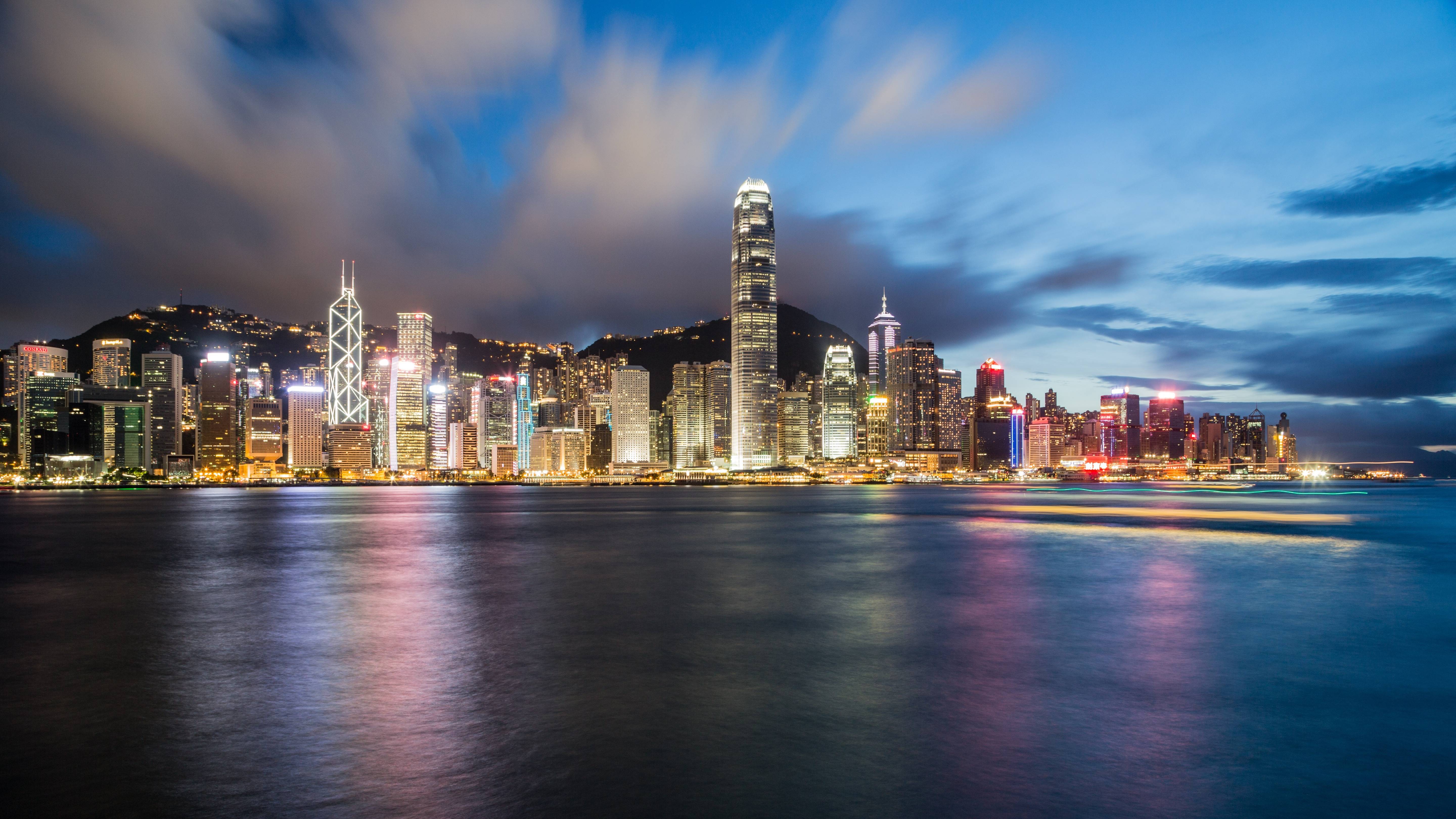 Hong Kong skyline at night with reflections on the water HD Wallpaper