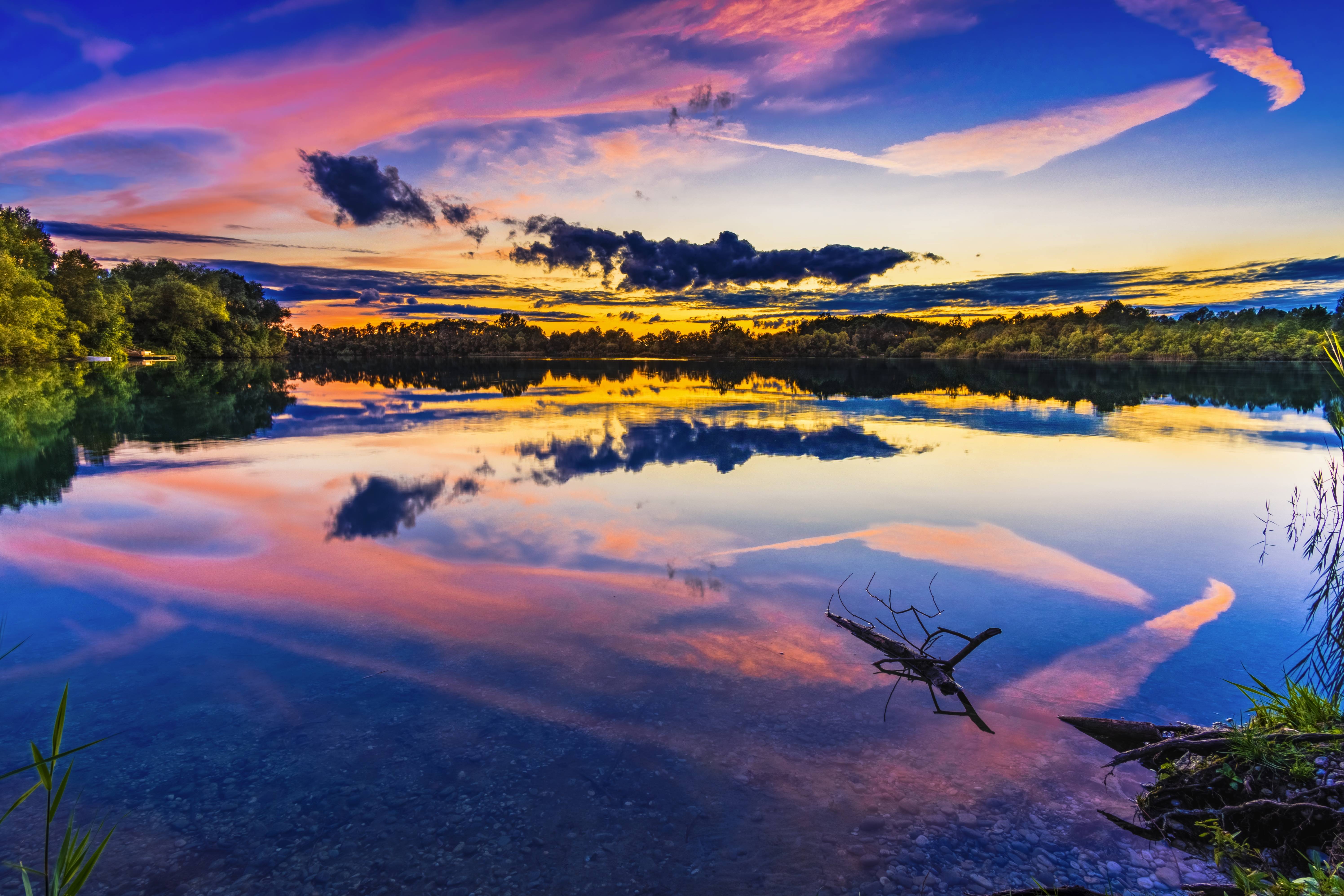Lake landscape with colorful sunset clouds reflected in water HD Wallpaper