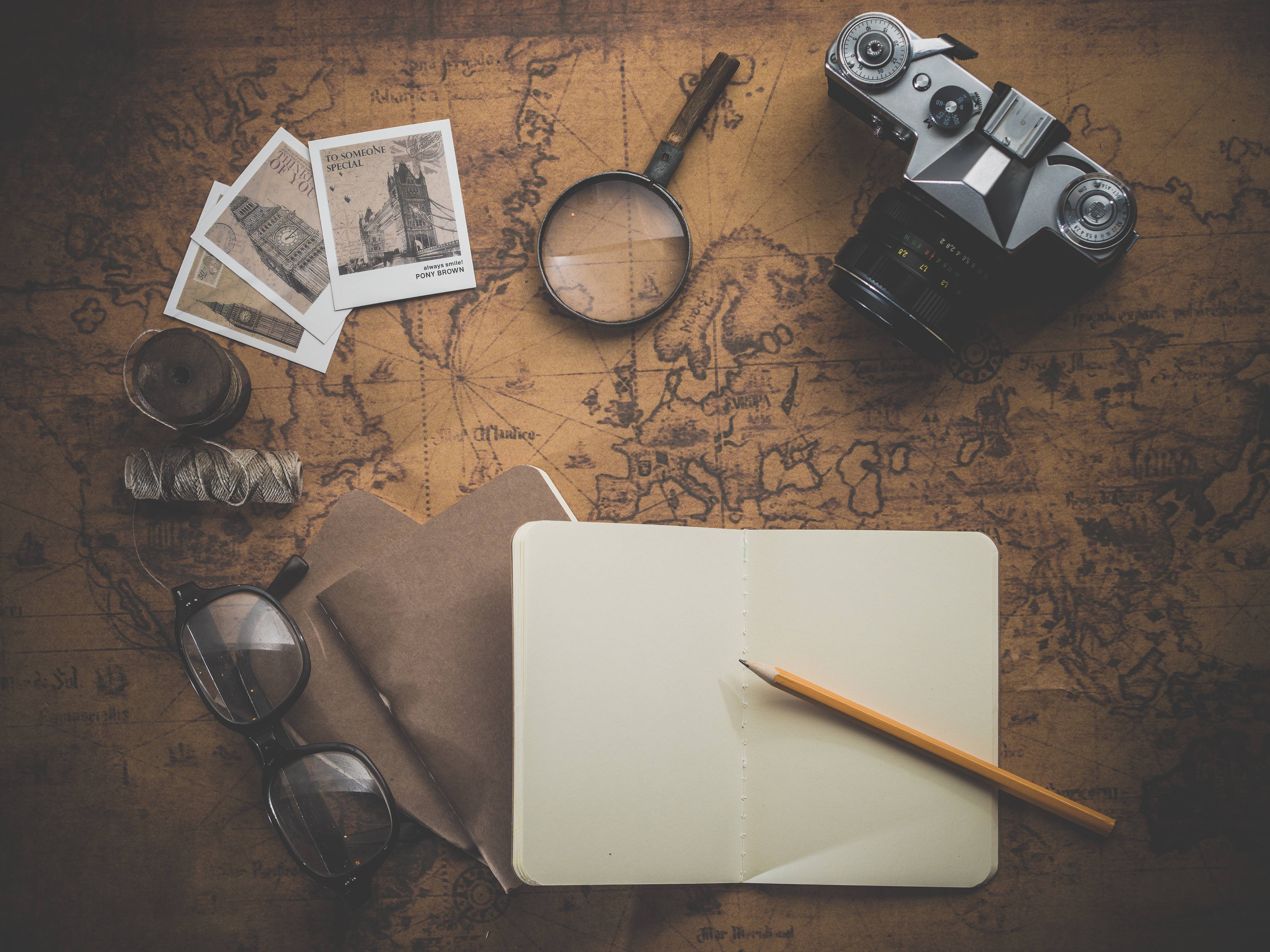 Vintage travel items on an old map HD Wallpaper