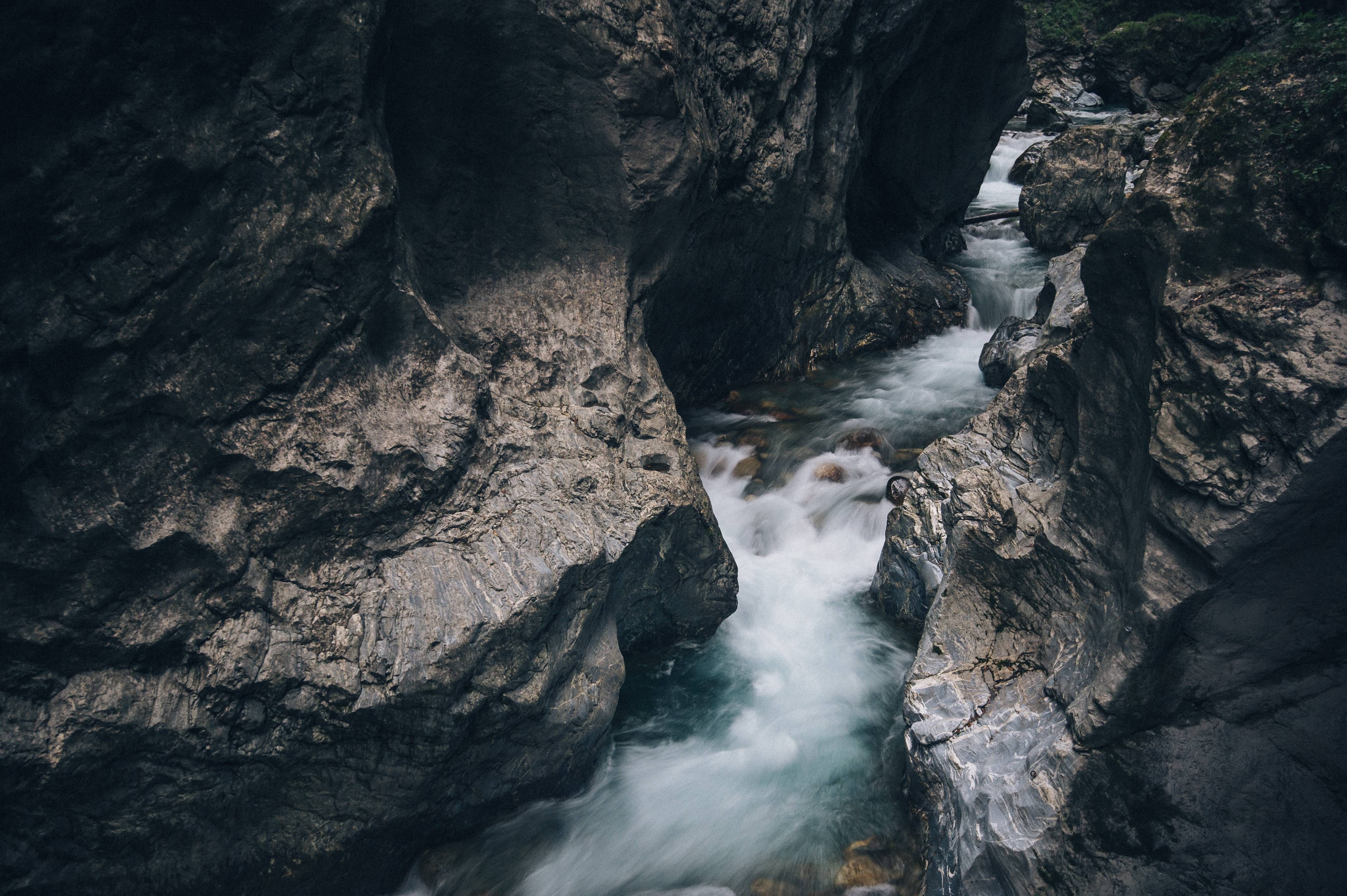 A river flows through a rocky canyon HD Wallpaper
