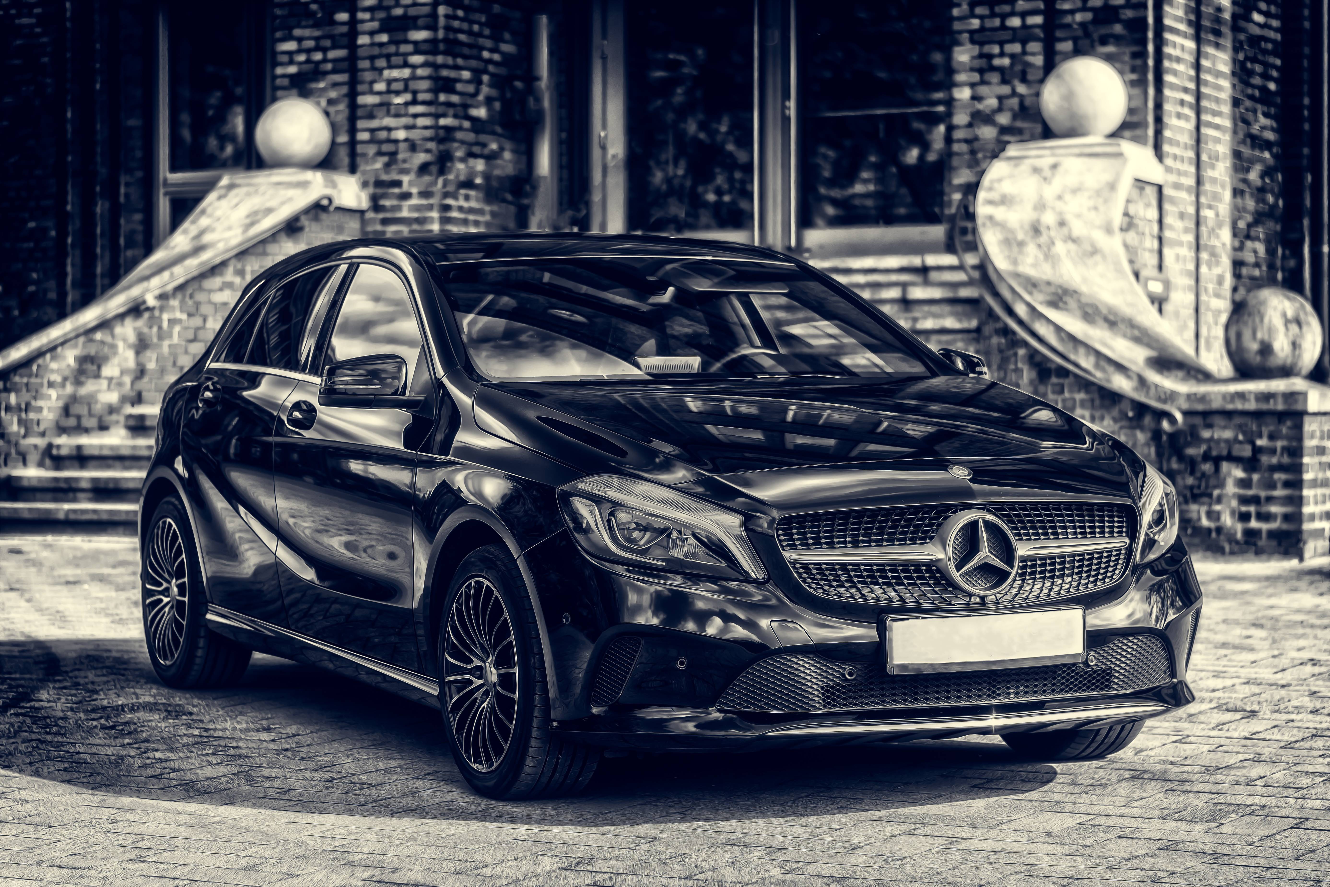 Black Mercedes-Benz A-Class parked in front of a building HD Wallpaper