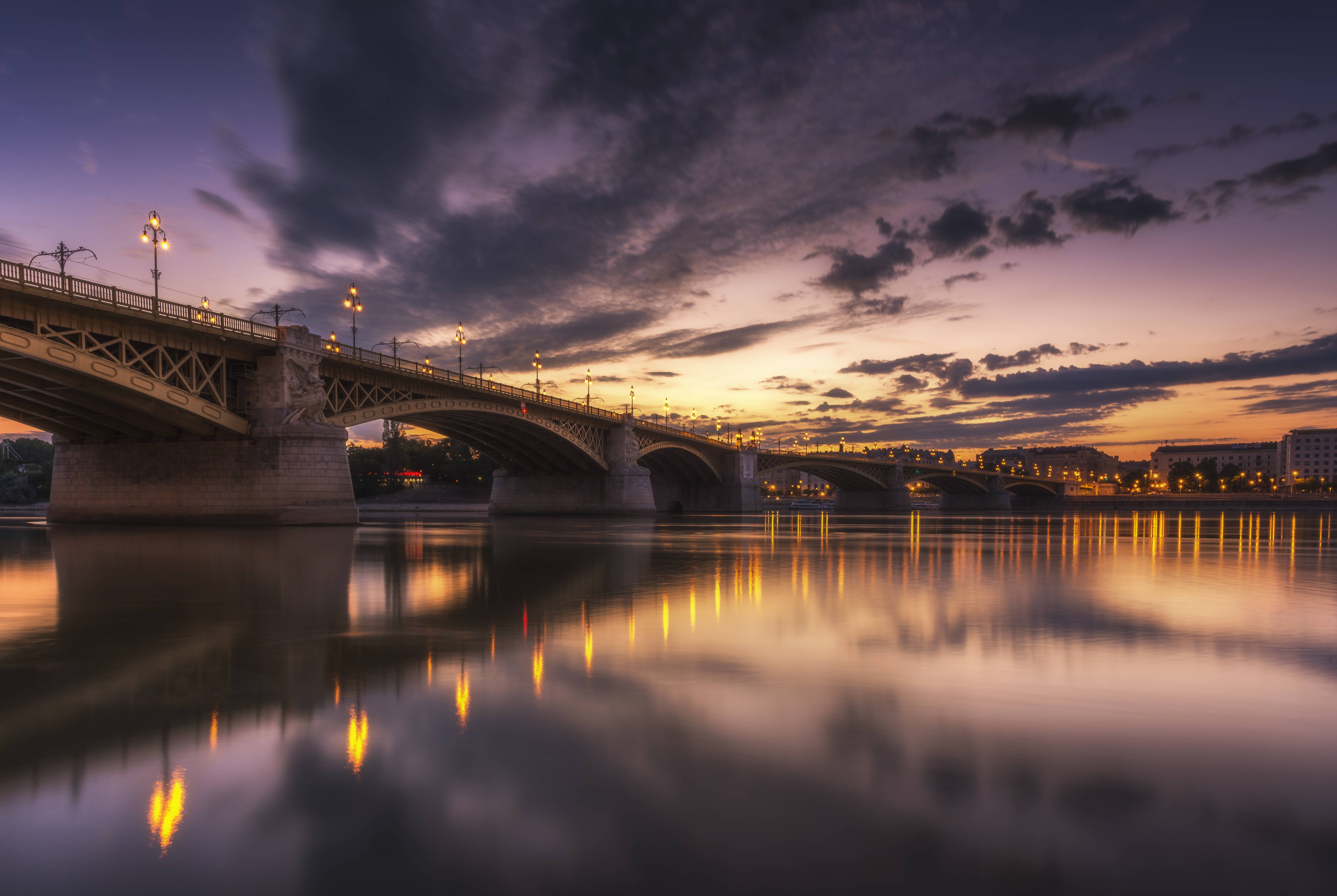 Bridge over river at dusk with city lights HD Wallpaper