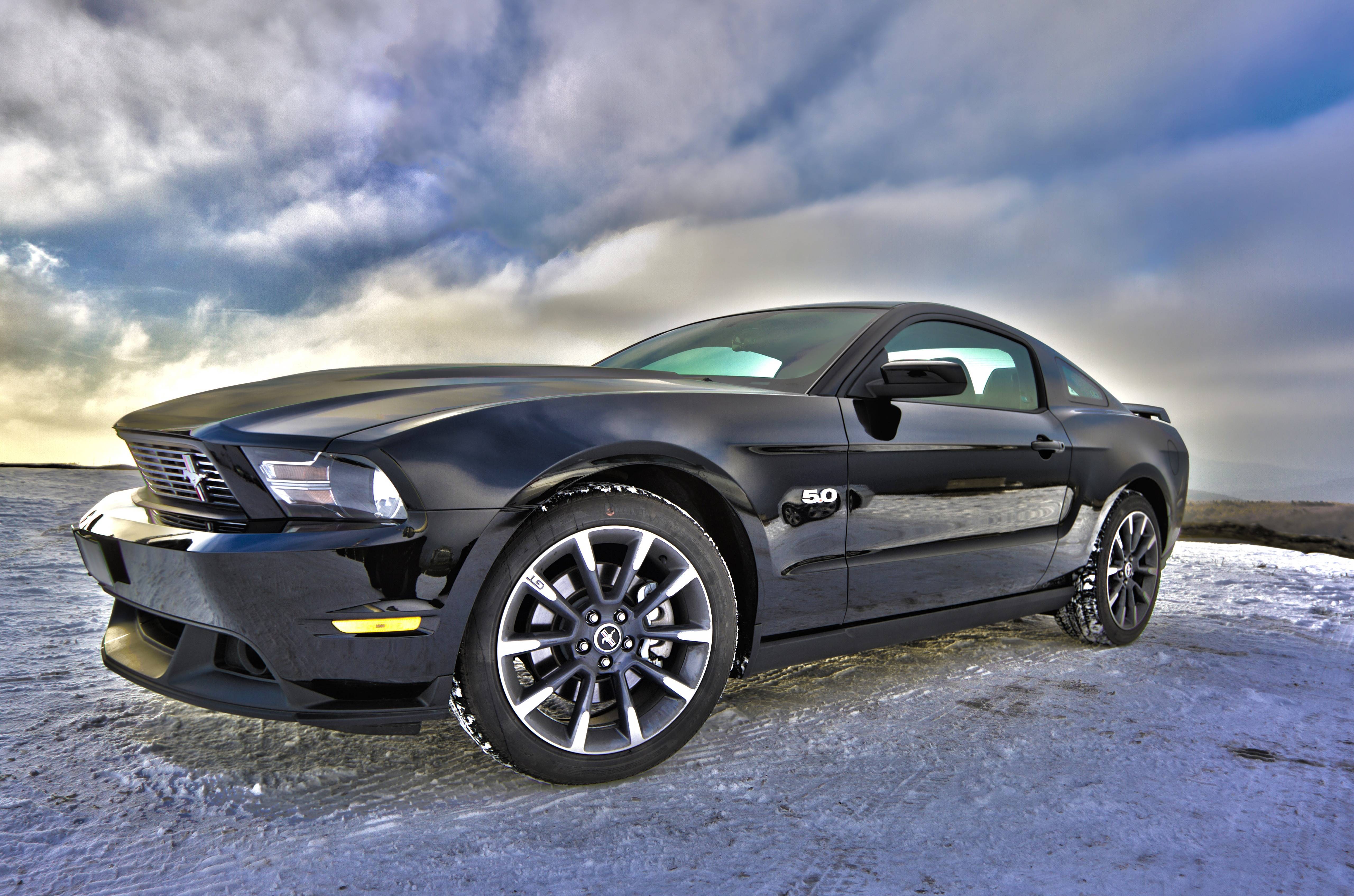 Black Ford Mustang 5.0 parked on a snowy landscape HD Wallpaper