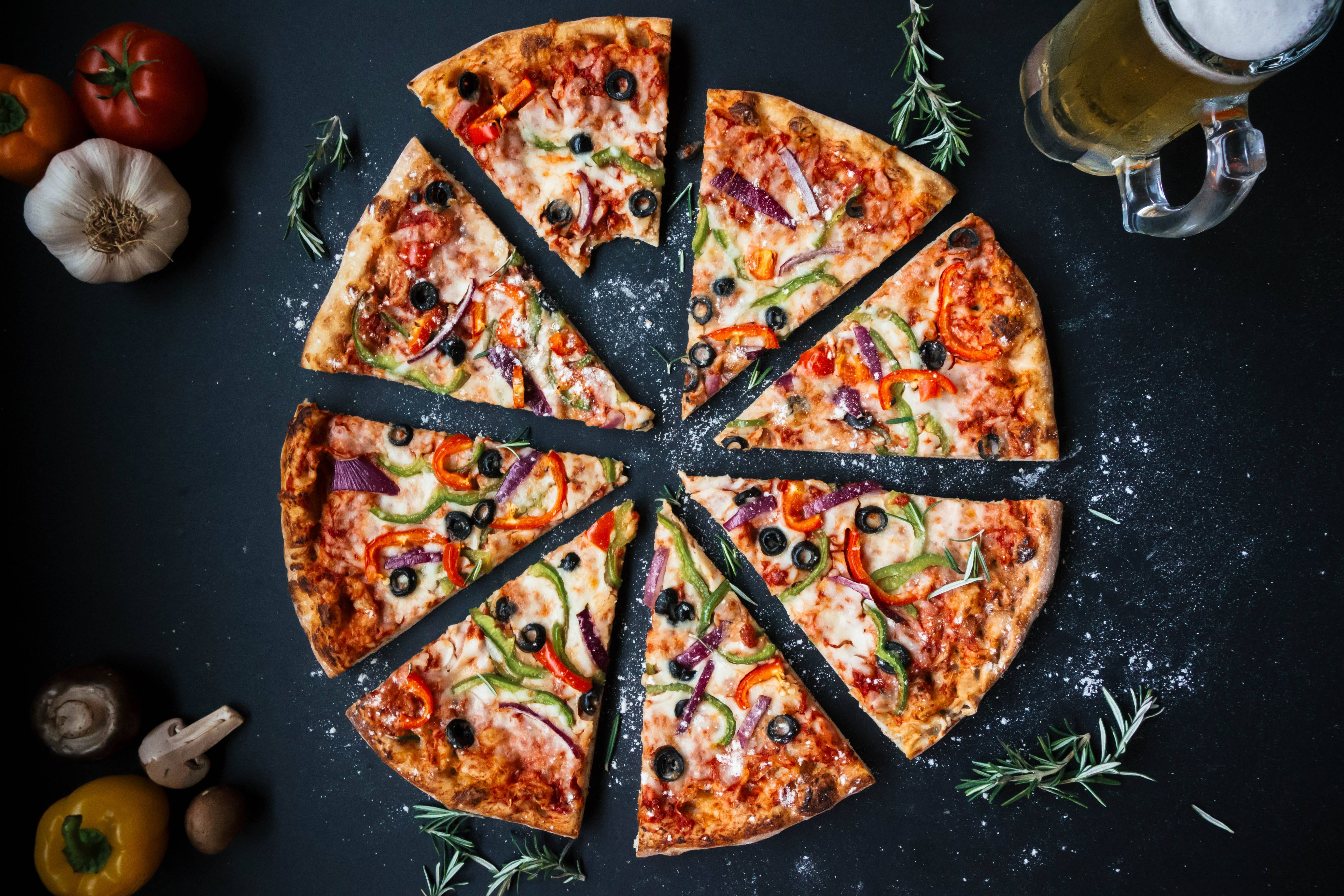 Delicious pizza slices with vegetables and a glass of beer HD Wallpaper