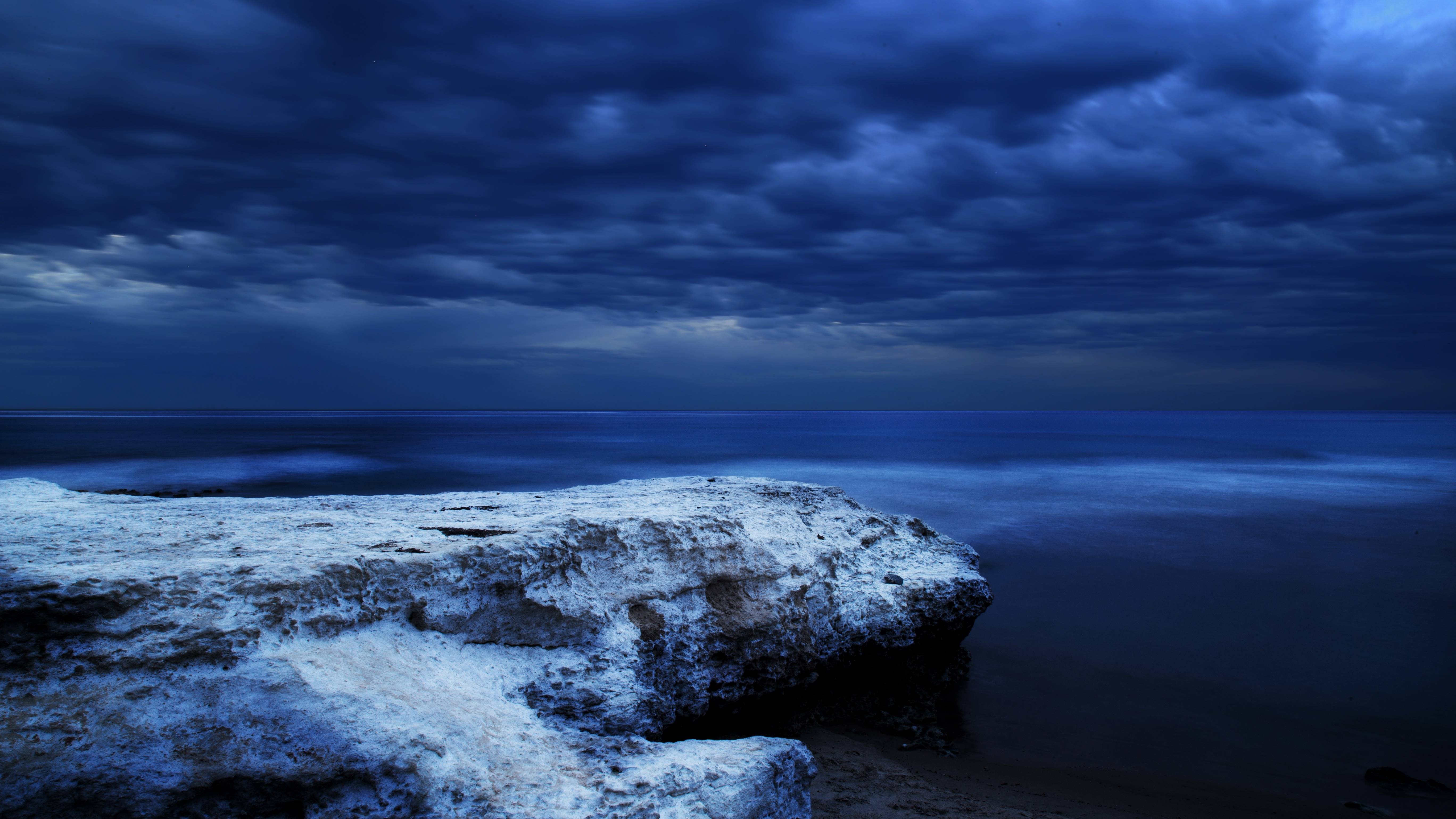 Dark Ocean and Rocky Shore at Twilight HD Wallpaper