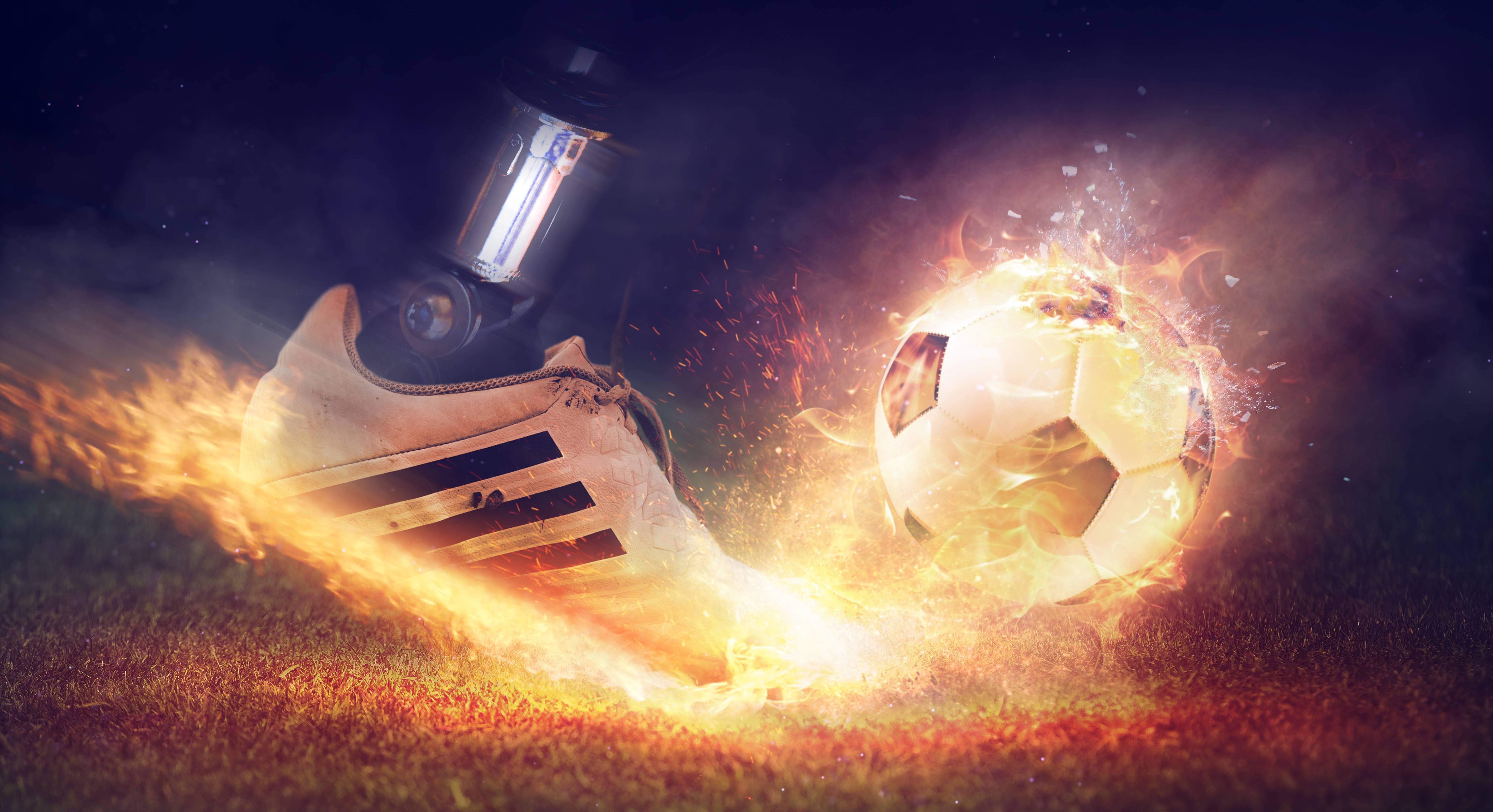 Soccer boot kicking a flaming football HD Wallpaper