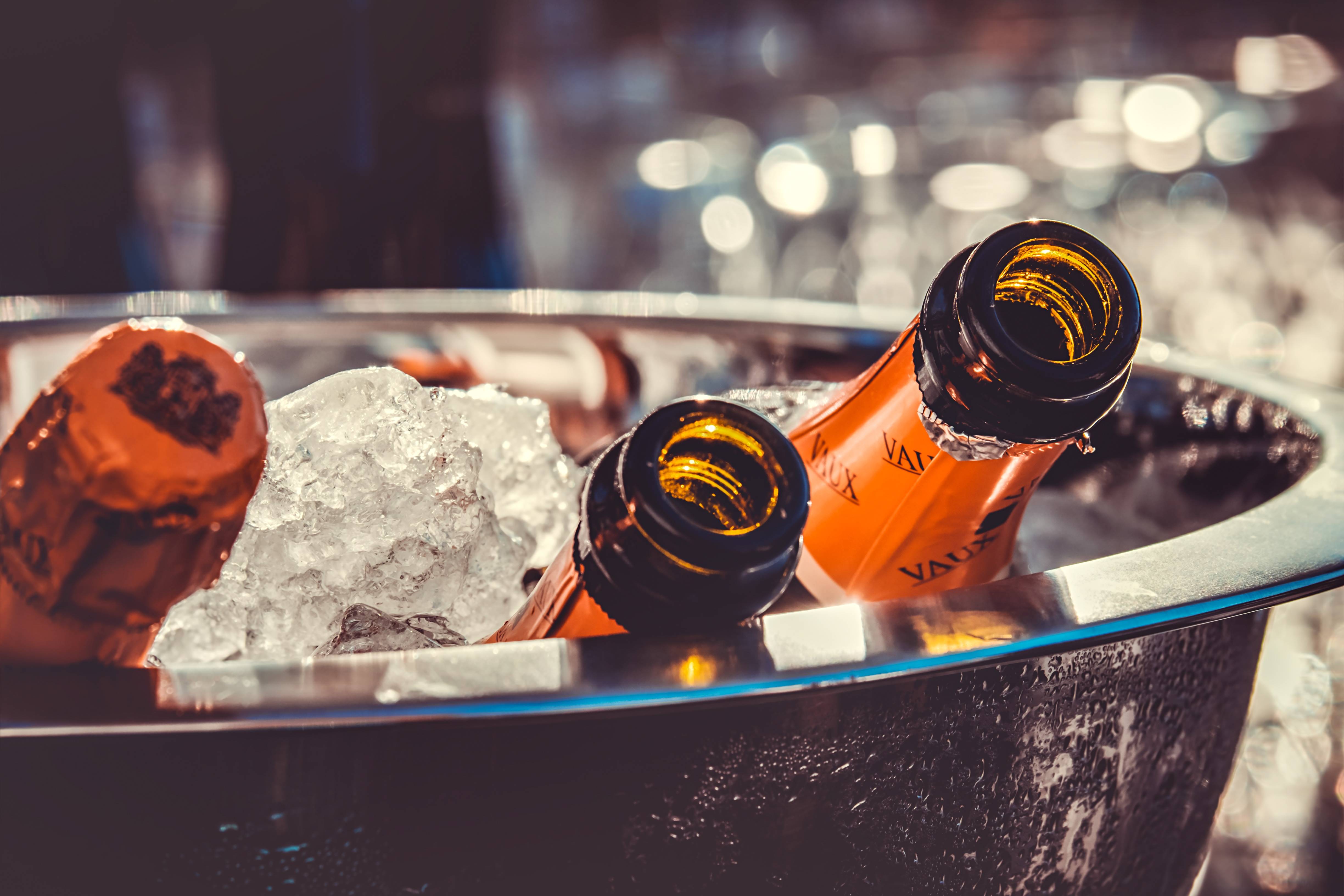 Champagne bottles chilling in an ice bucket HD Wallpaper