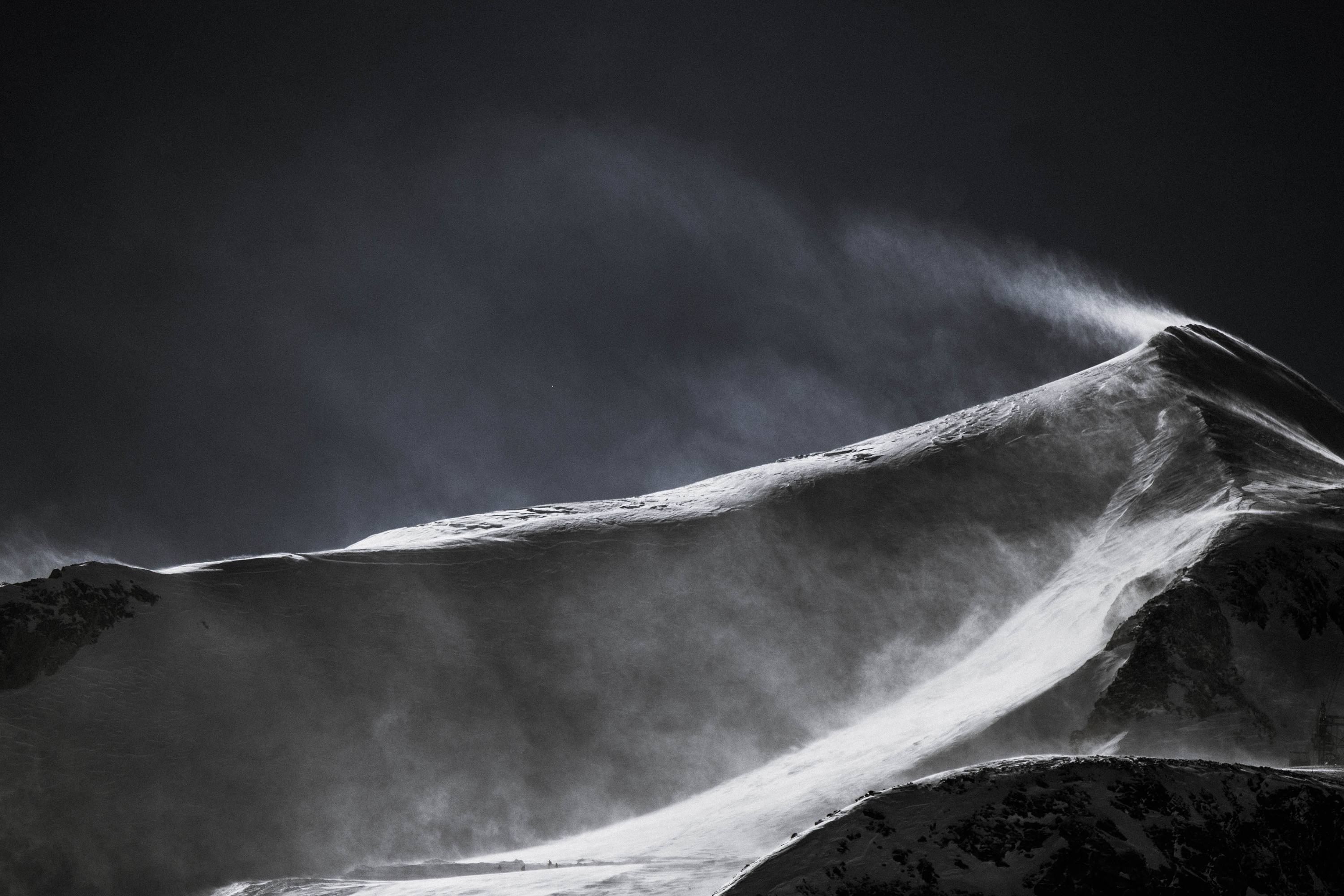 Snowy mountain peak with wind blowing snow HD Wallpaper