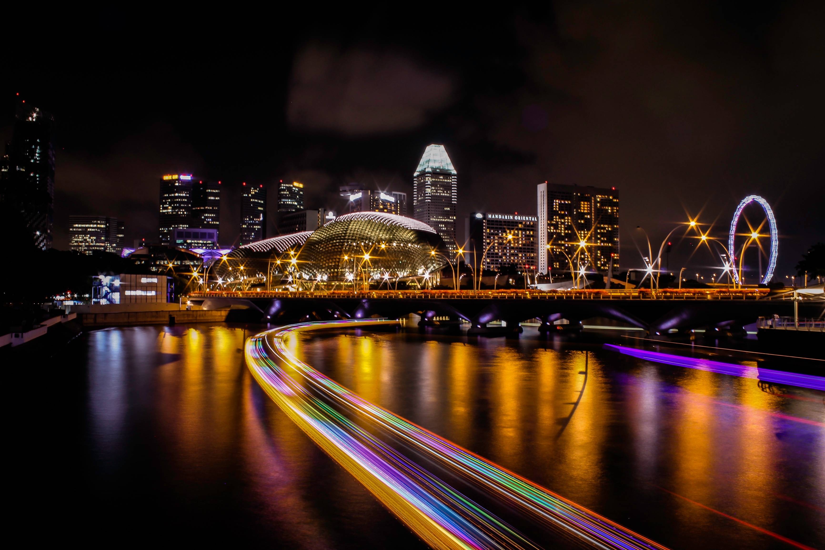 Singapore skyline at night with light trails on the river HD Wallpaper