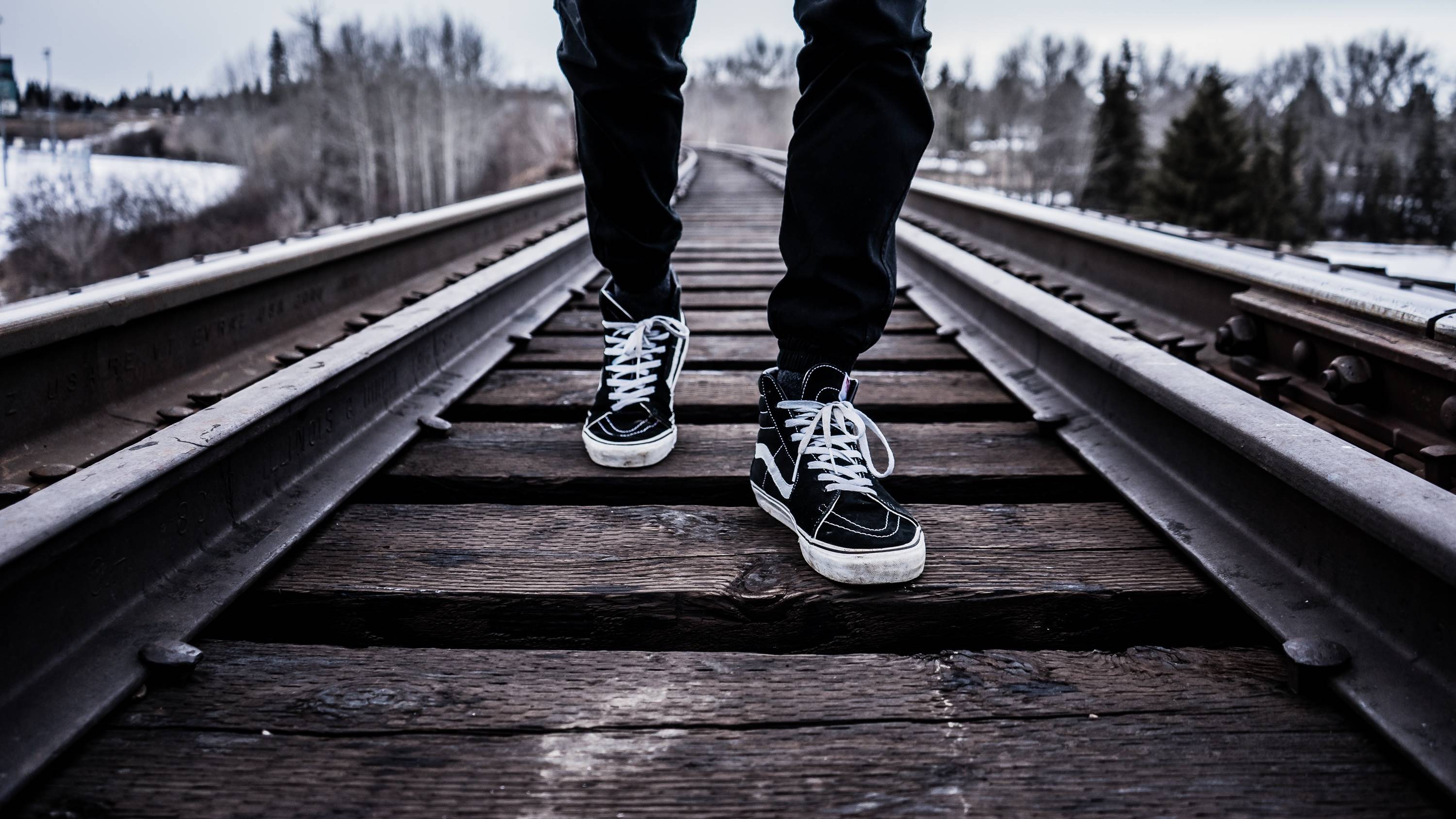 Person walking on railroad tracks HD Wallpaper