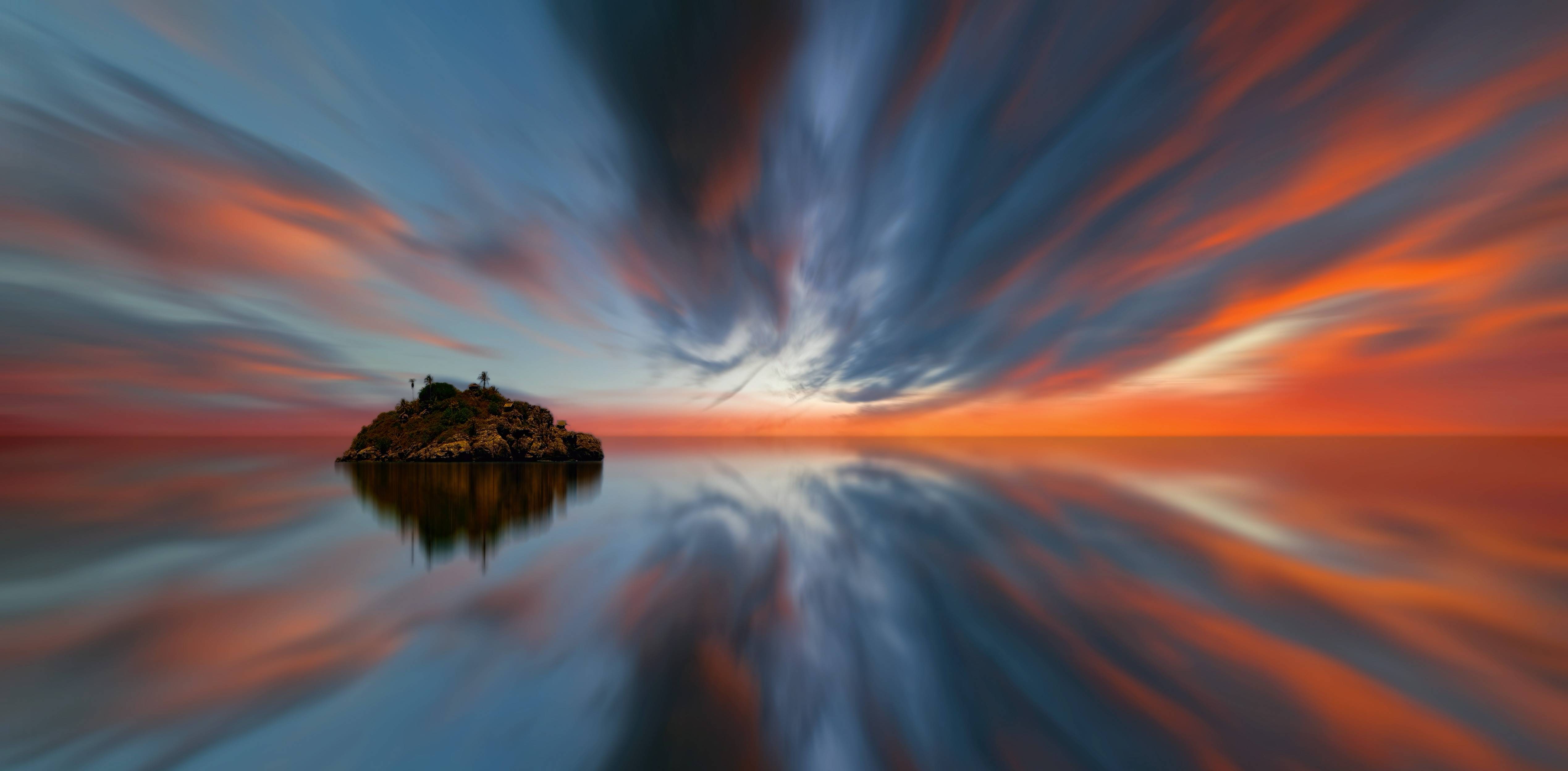 Island in the ocean during sunset with reflection HD Wallpaper